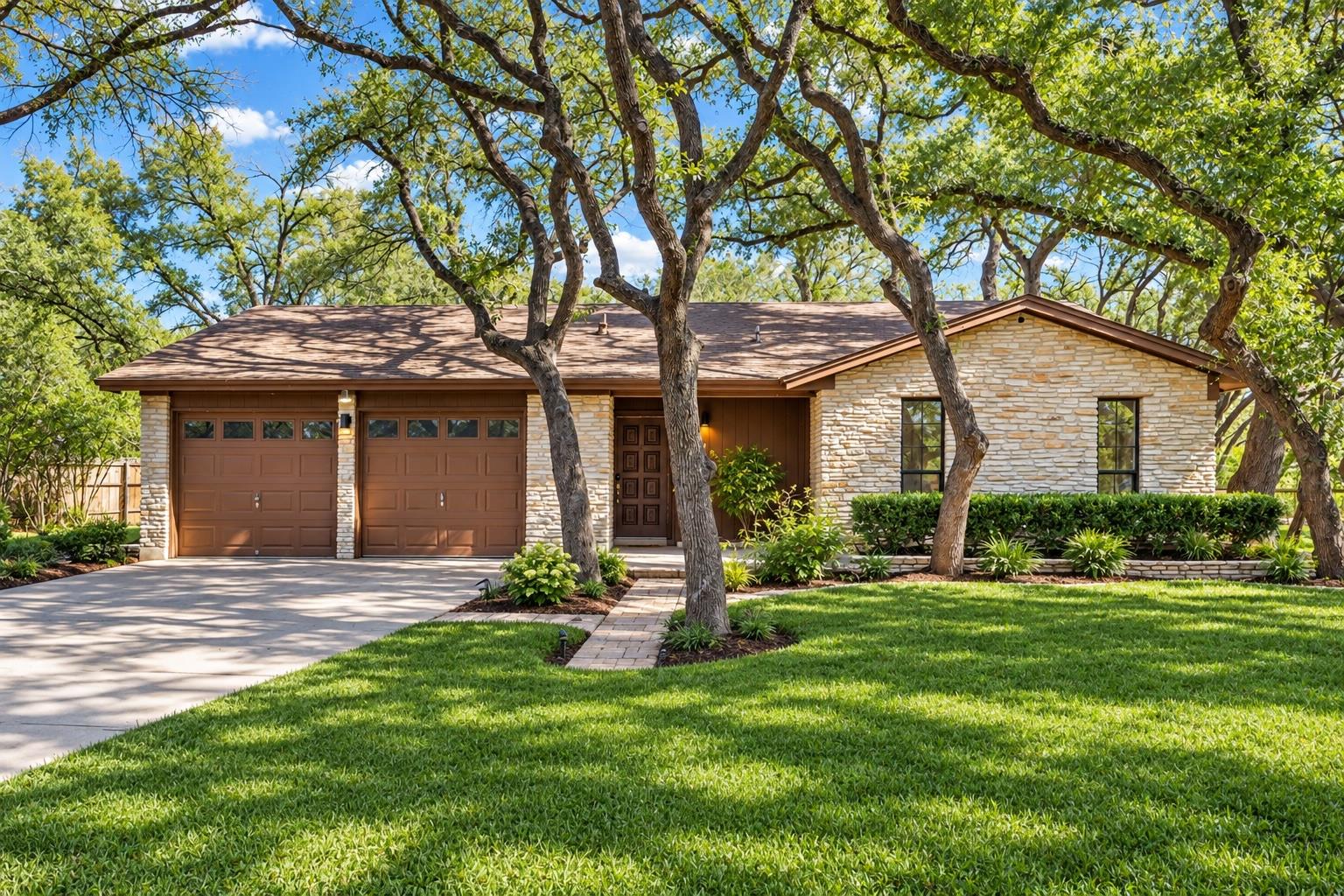 Mature trees shade a classic stone exterior featu