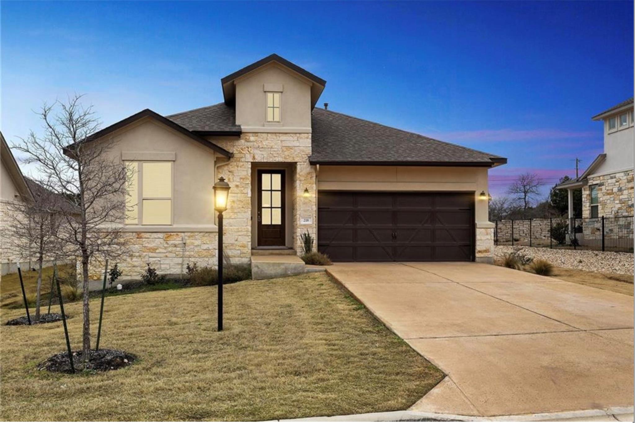 View of front of property featuring stone siding,