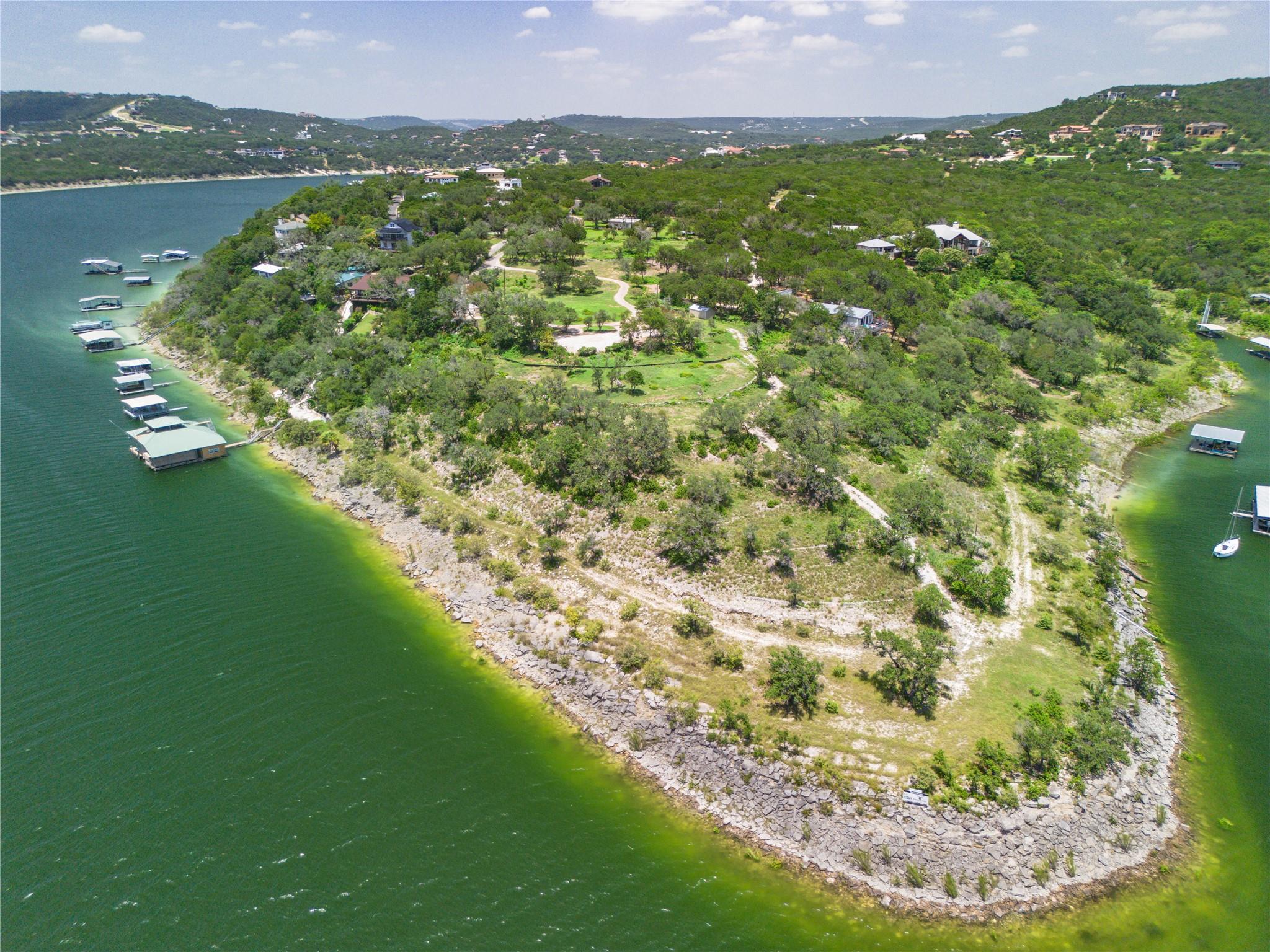 Rolling green hills and rocky shorelines frame th