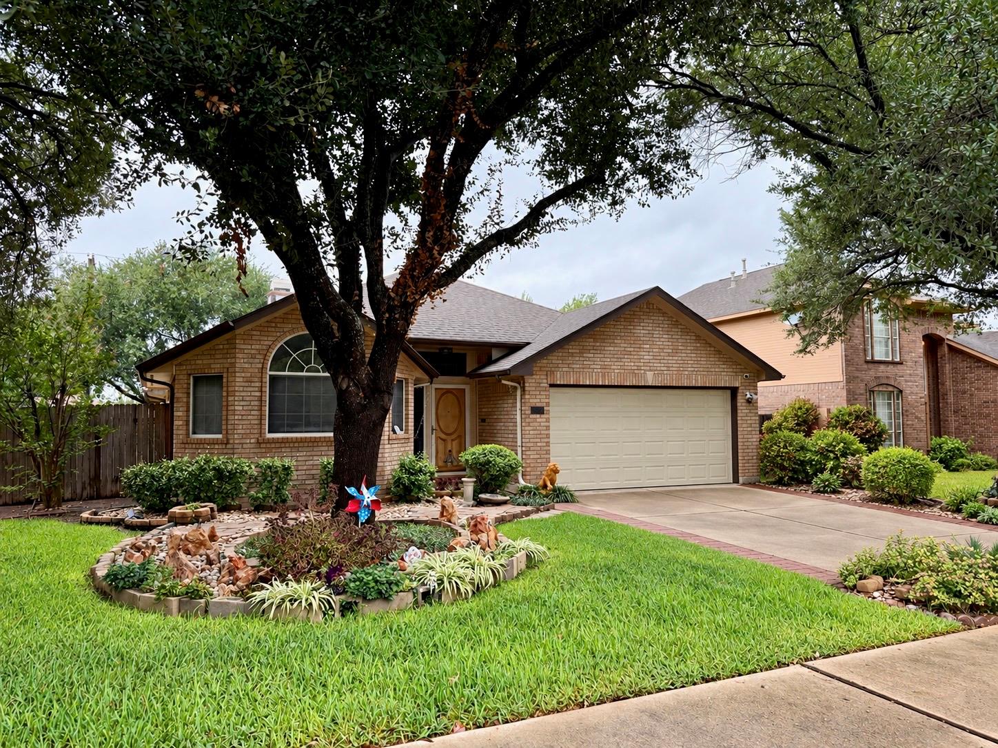 Mature trees shade the classic brick exterior of 