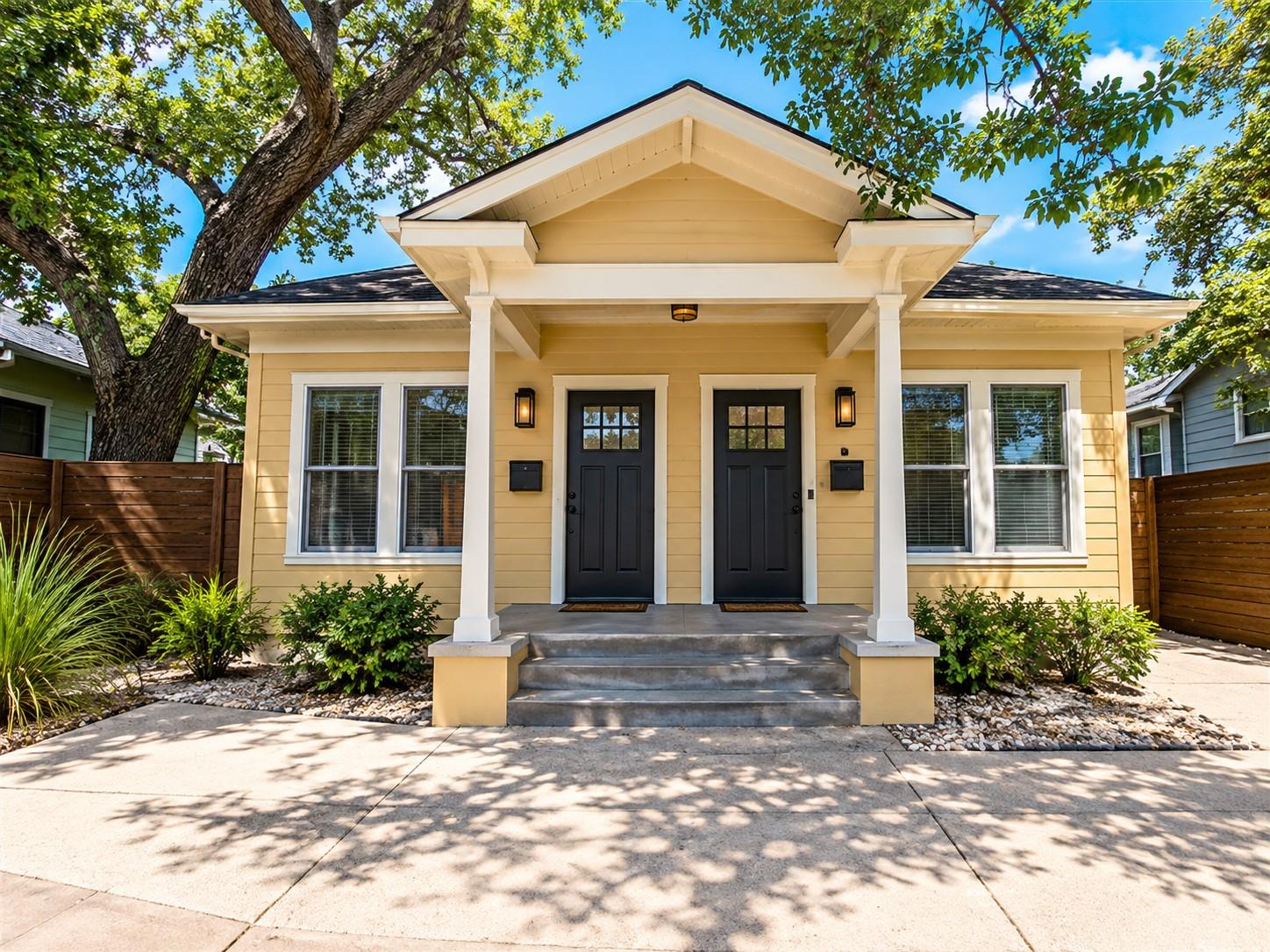 A welcoming front porch leads to the dual entries