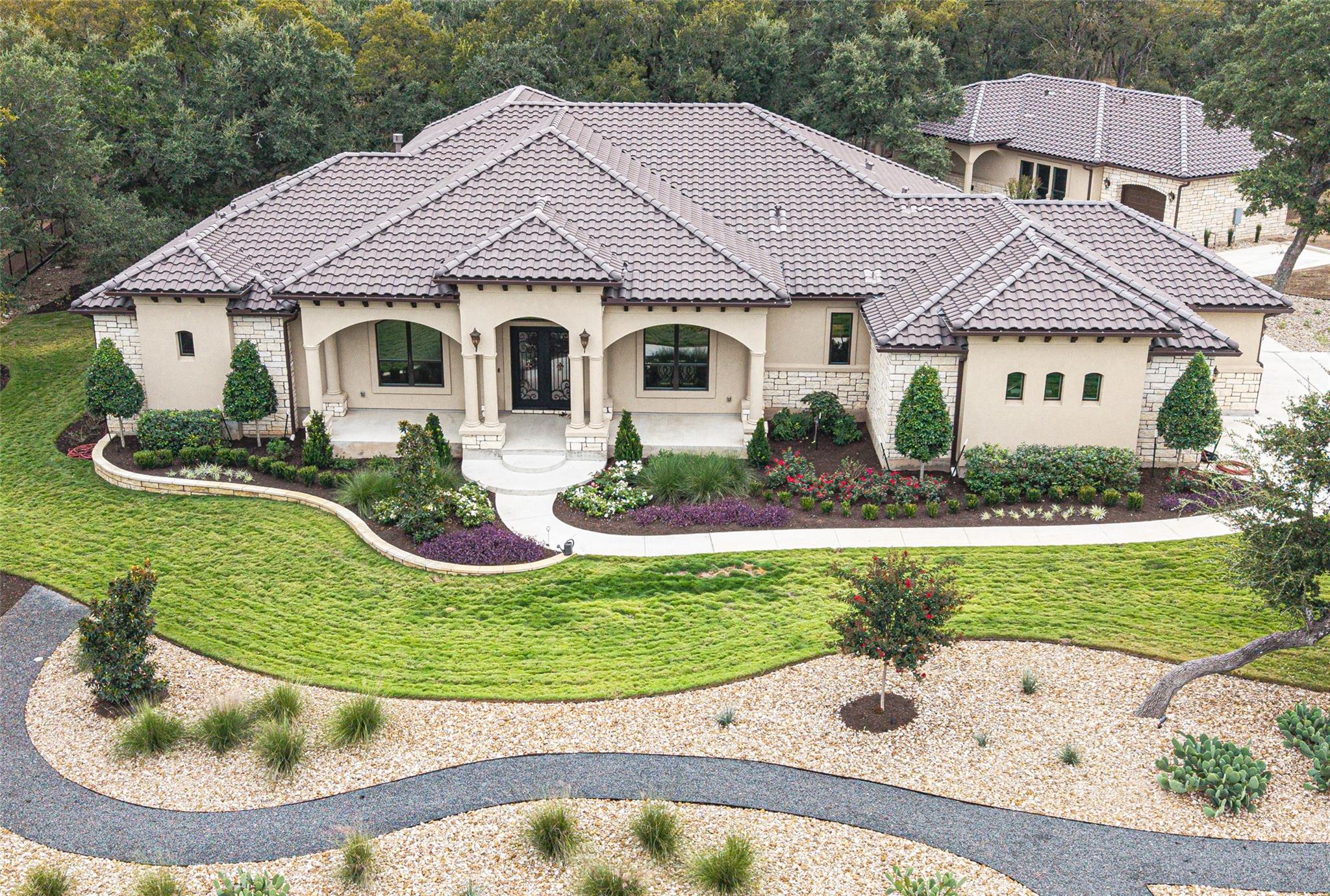 An elegant tile roof and arched entryways highlig
