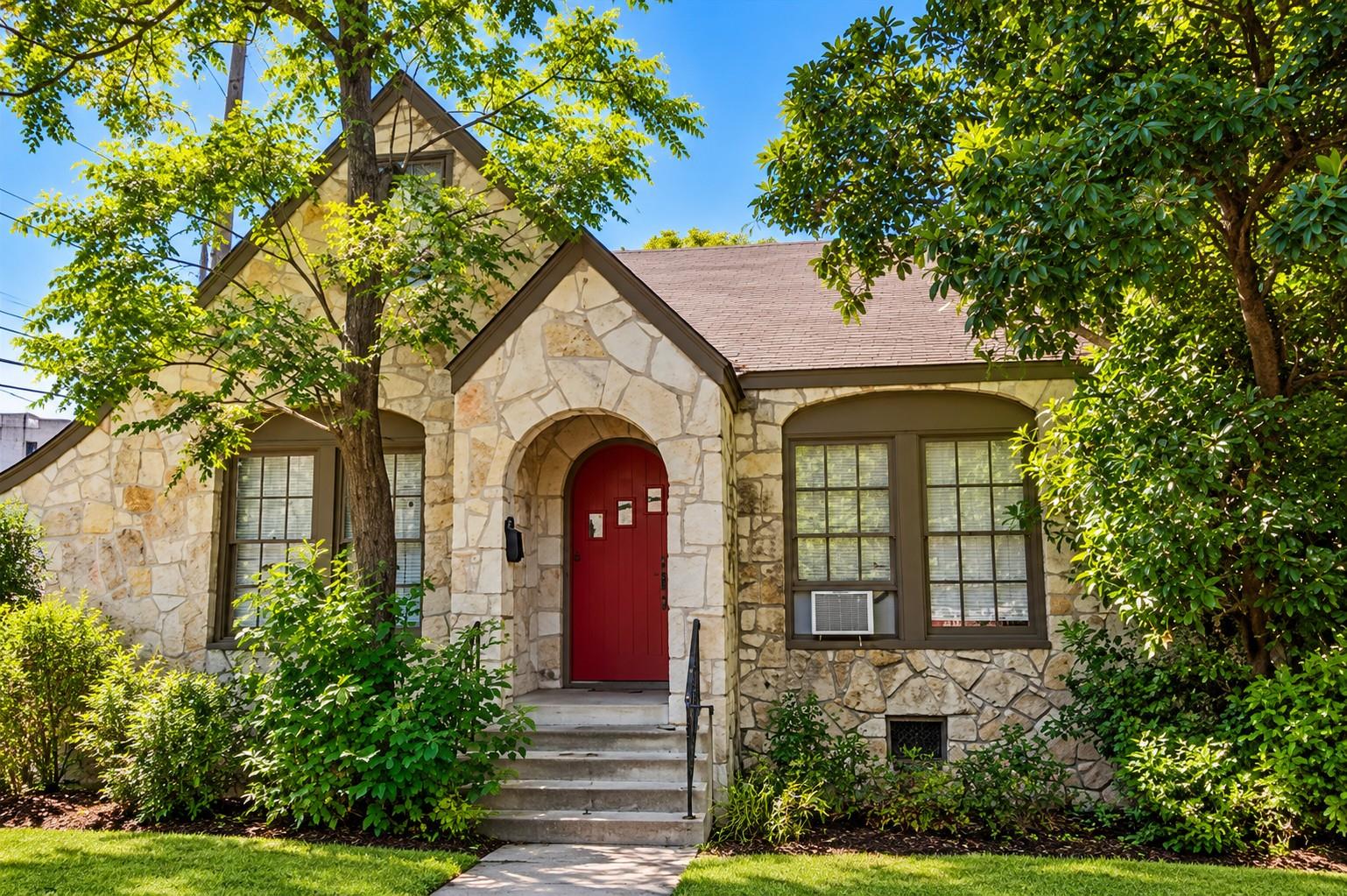 Mature trees shade a classic stone exterior with 