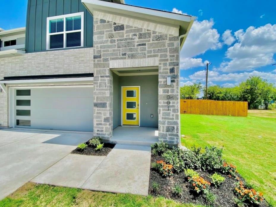 A welcoming stone entryway leads to a contemporar