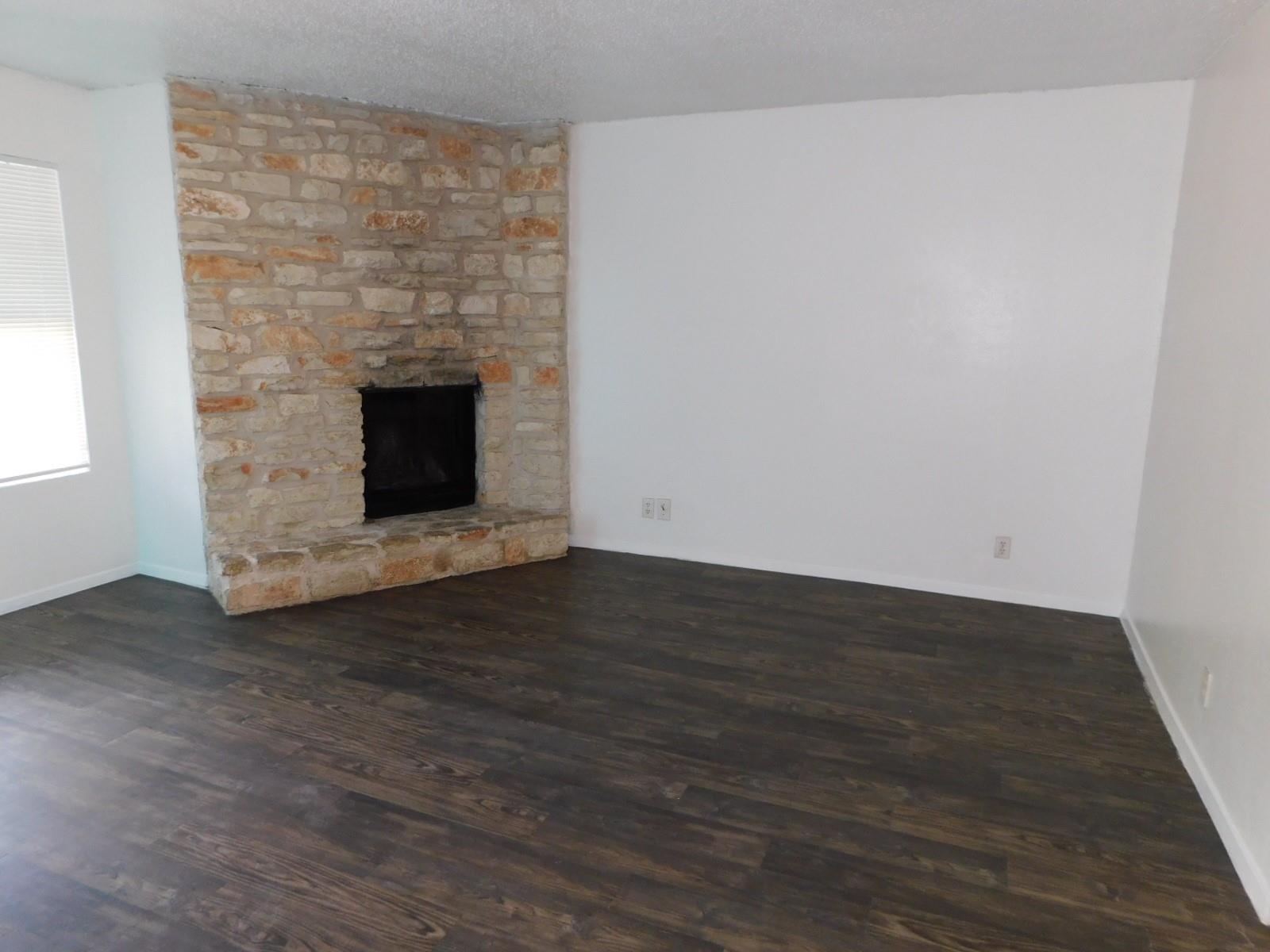 A classic floor-to-ceiling stone fireplace anchor