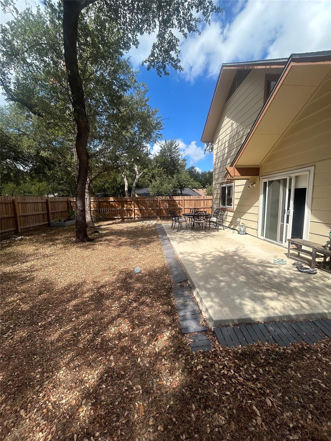 Mature trees shade a spacious backyard featuring 