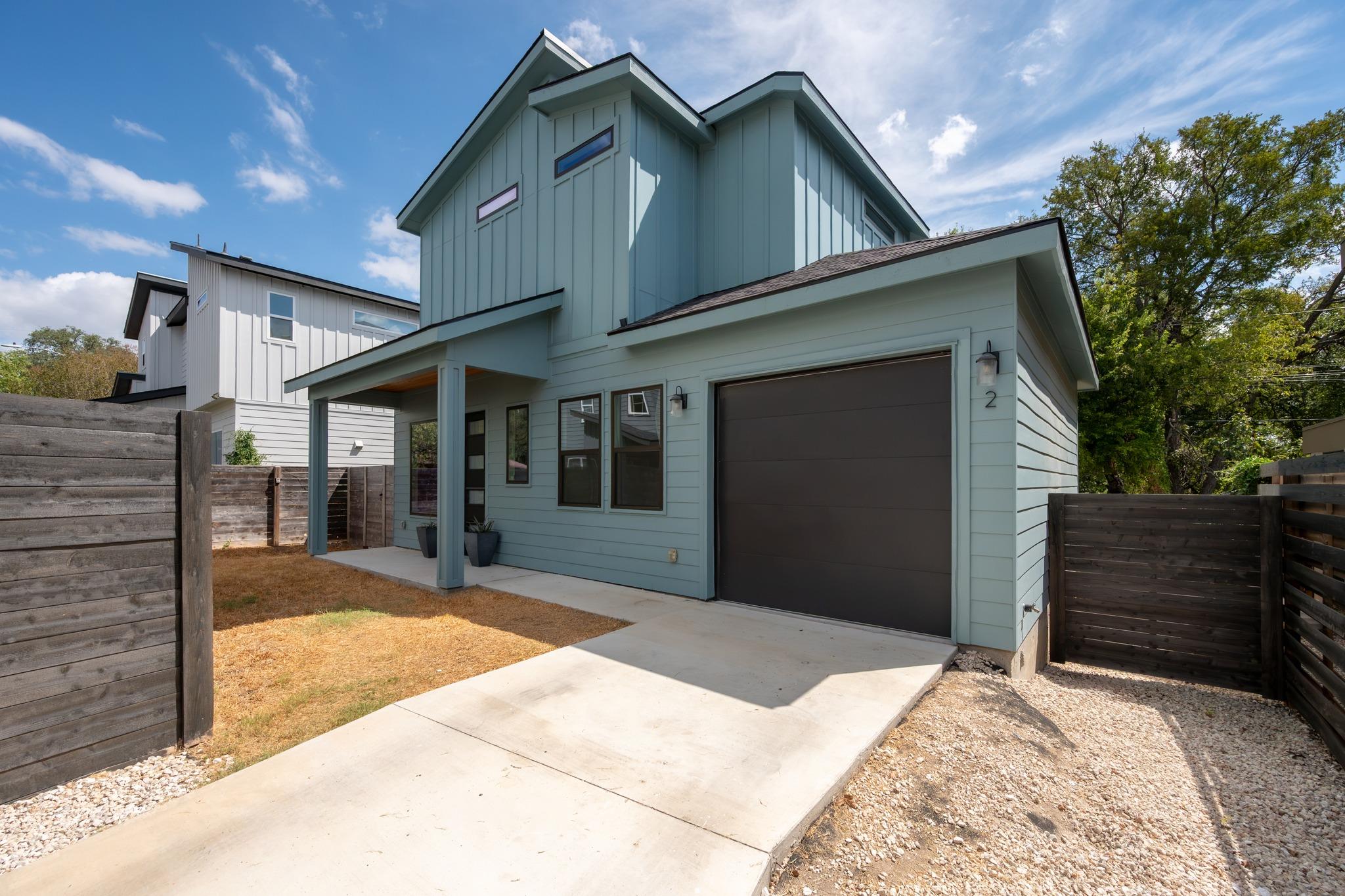 Modern vertical siding and a neat concrete drivew