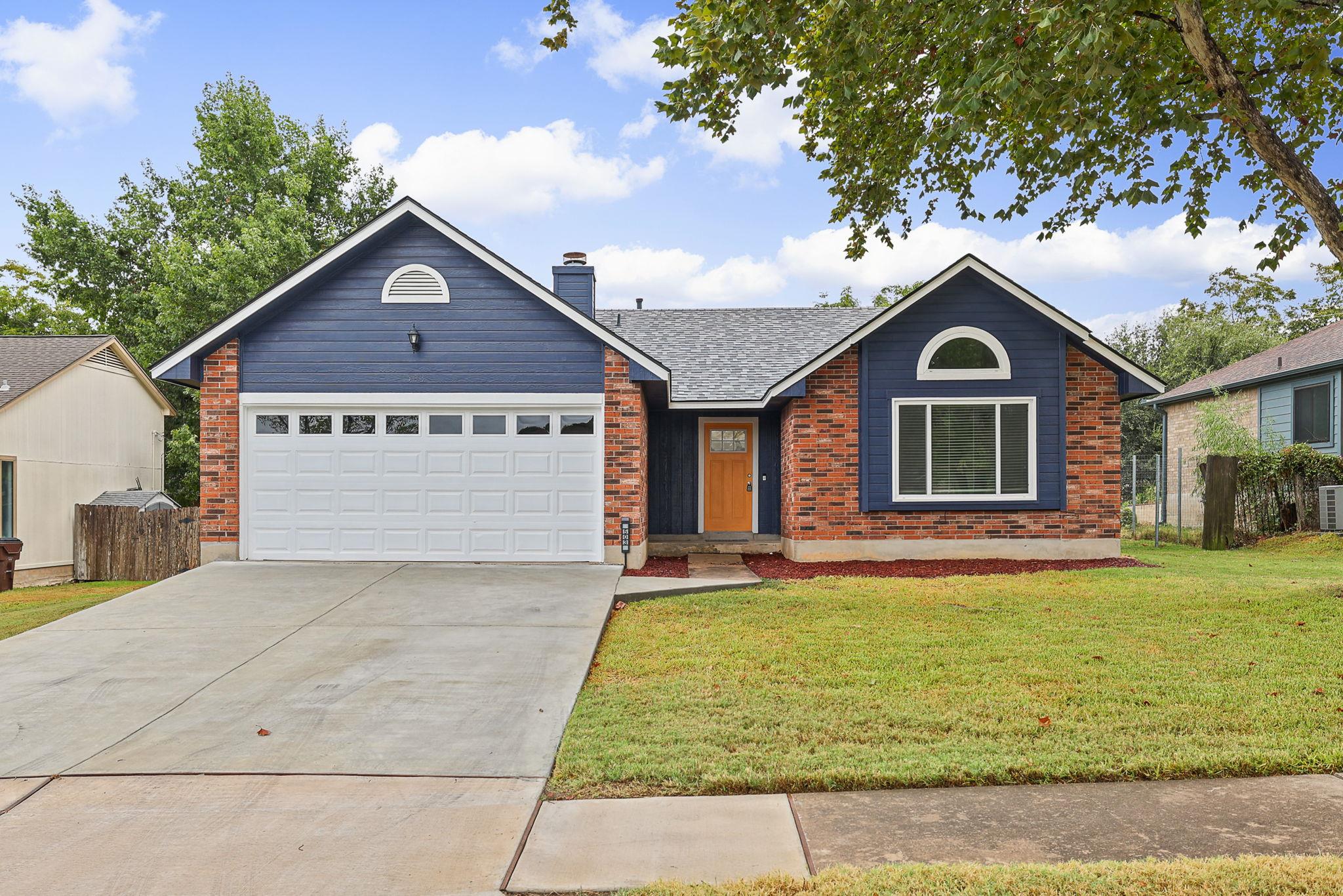 A concrete driveway leads toward this classic sin