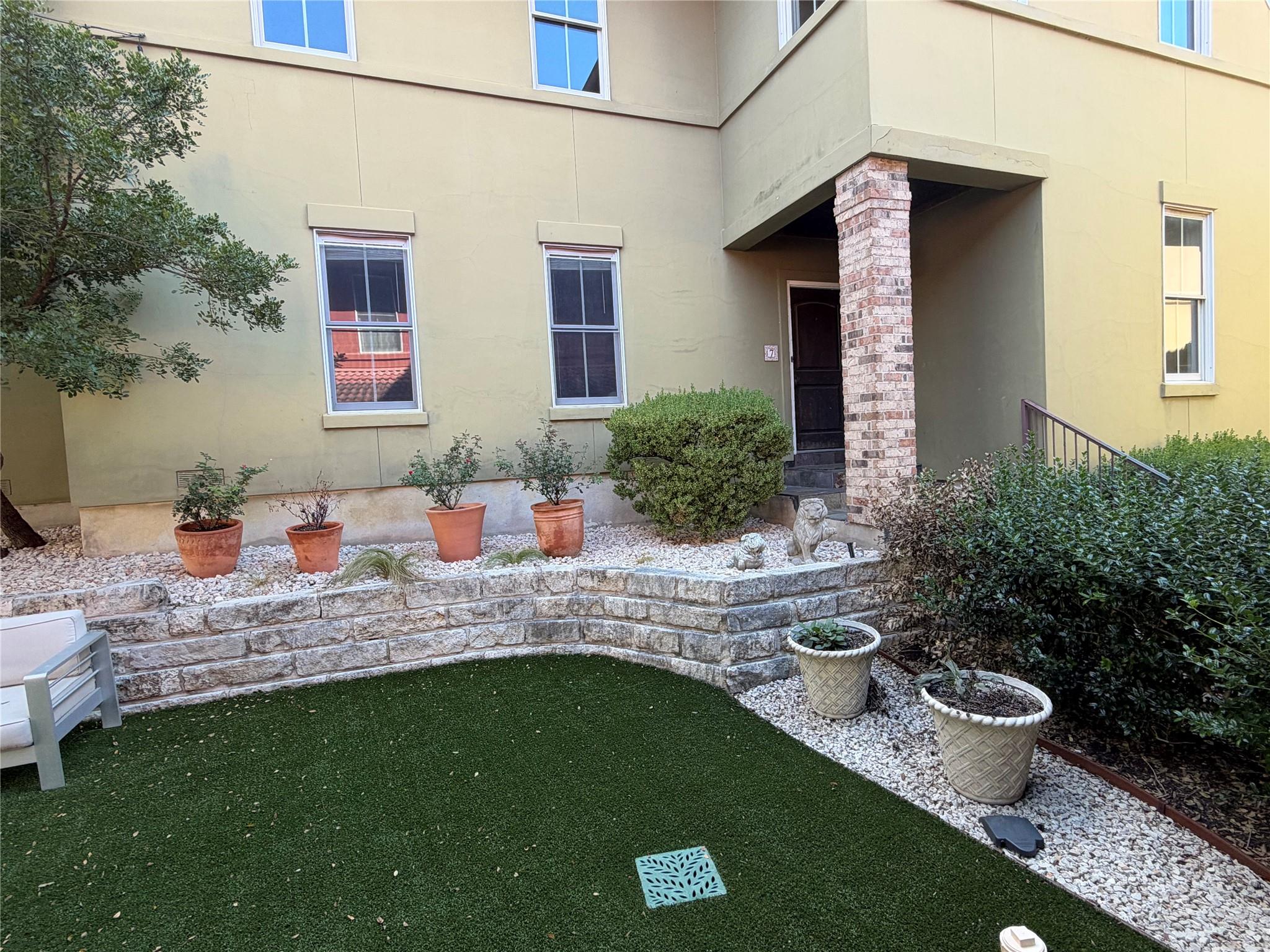 Multi-level stone retaining walls frame the manic