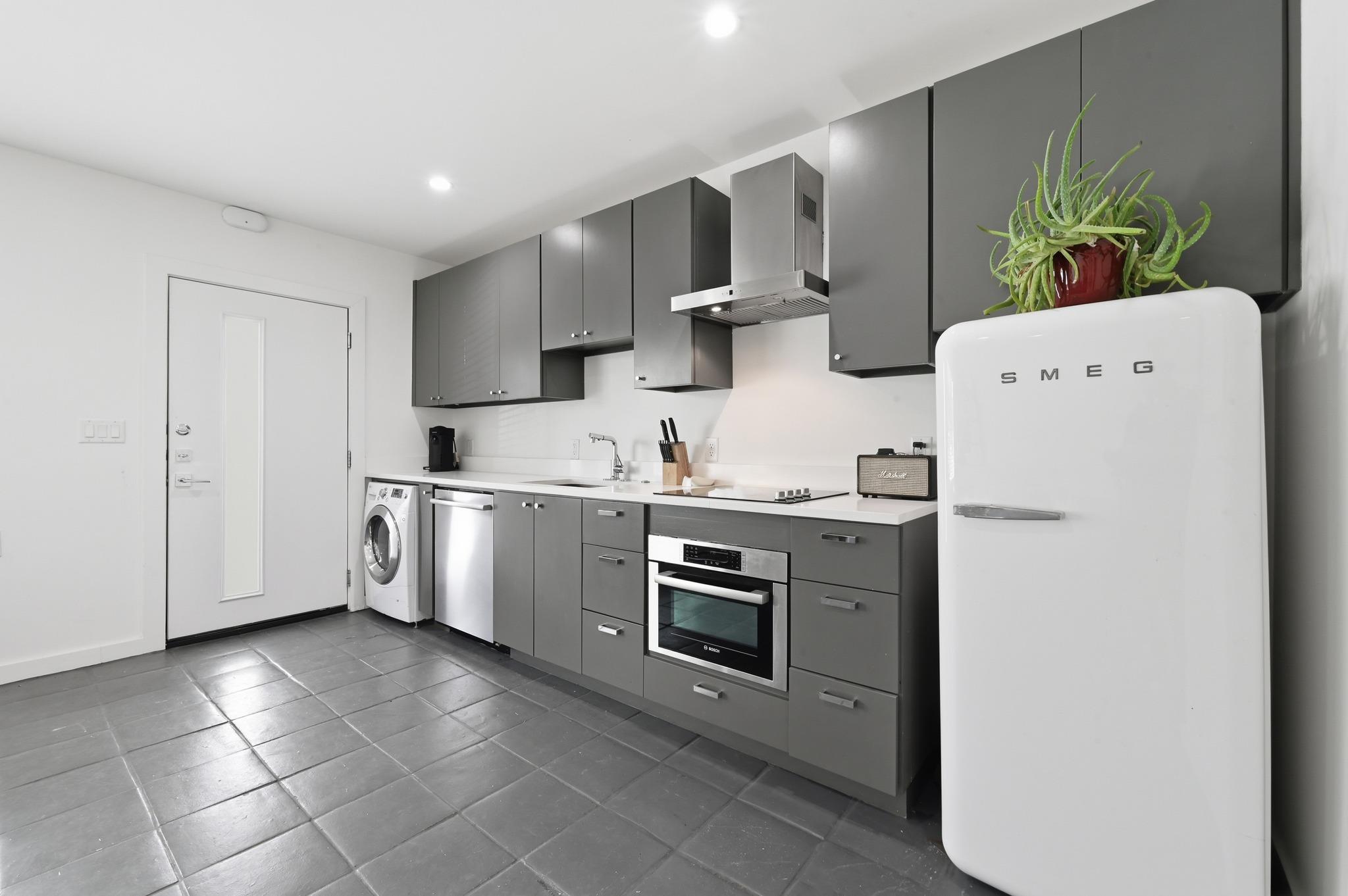 A sleek, contemporary kitchen with integrated app