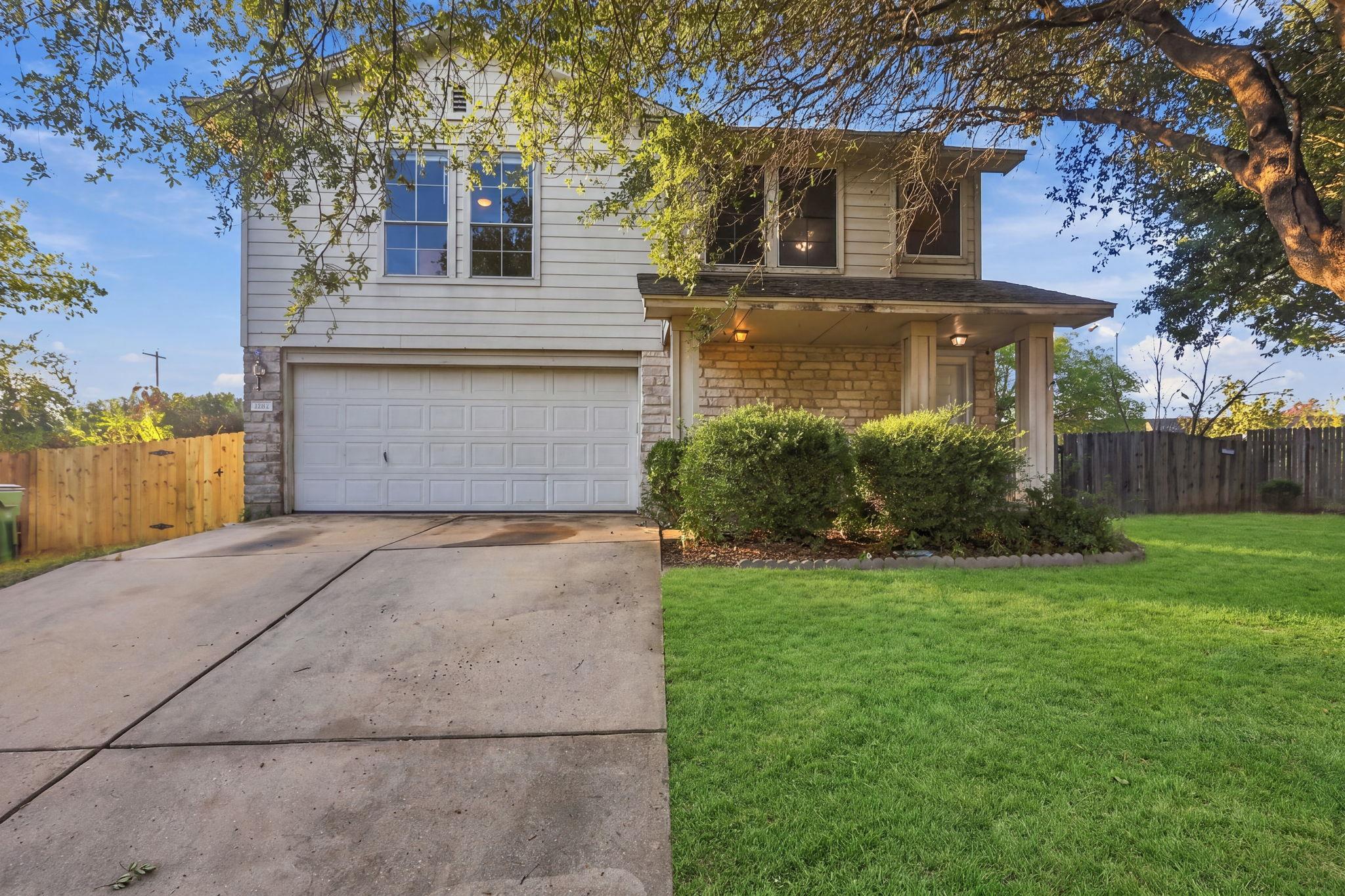 Mature trees shade a classic two-story exterior f