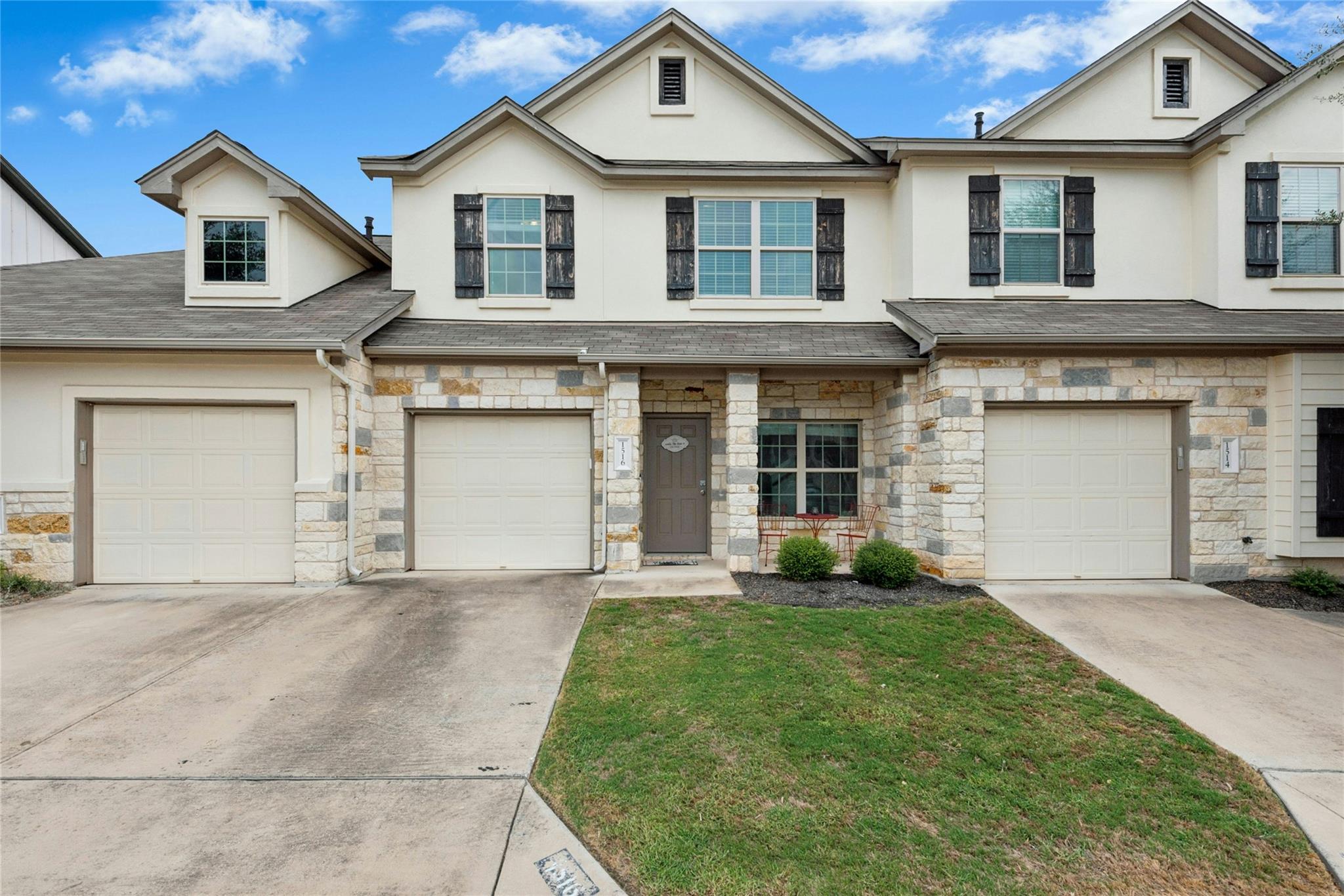 Stone and stucco accents define the multi-level e