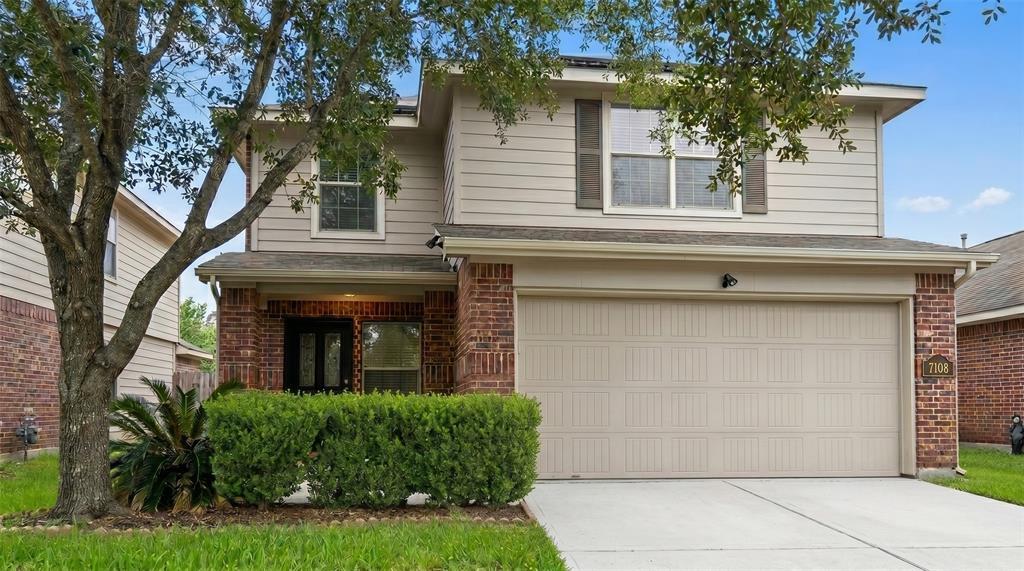 A classic brick and siding exterior features a fr