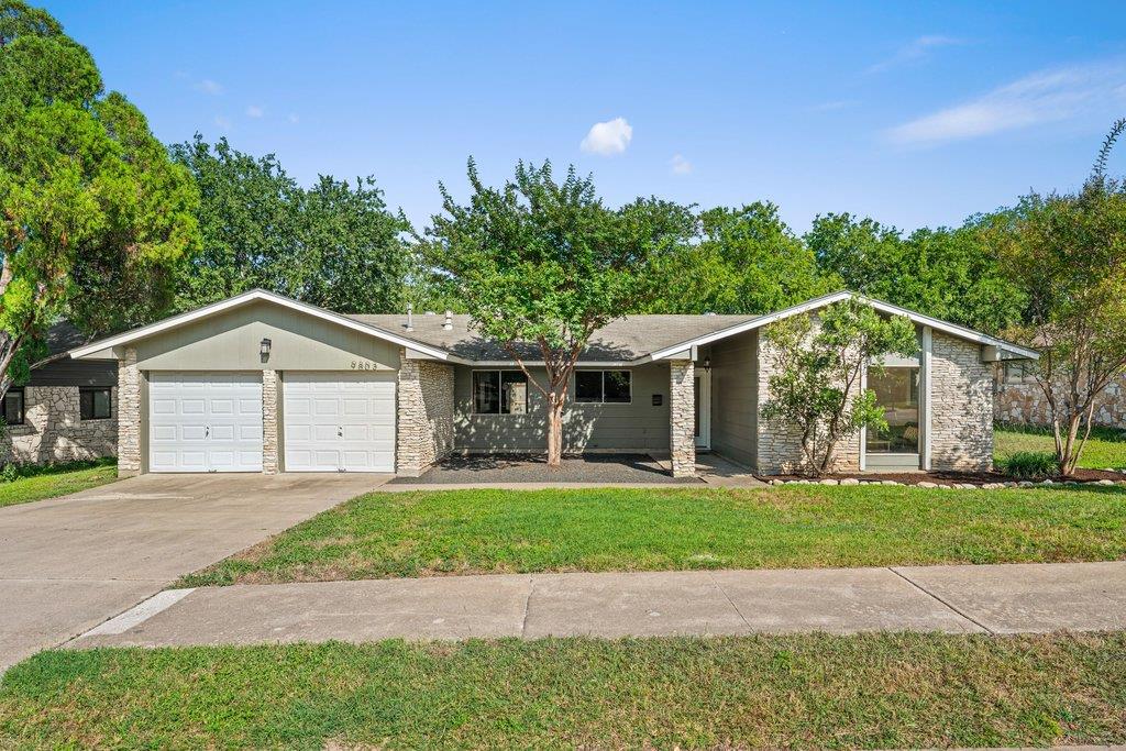 A classic ranch home showcasing a two-car garage,
