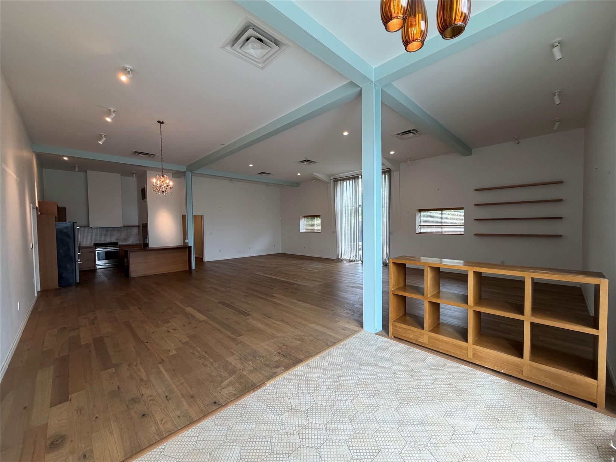 Gleaming hardwood floors and a lofty beamed ceili