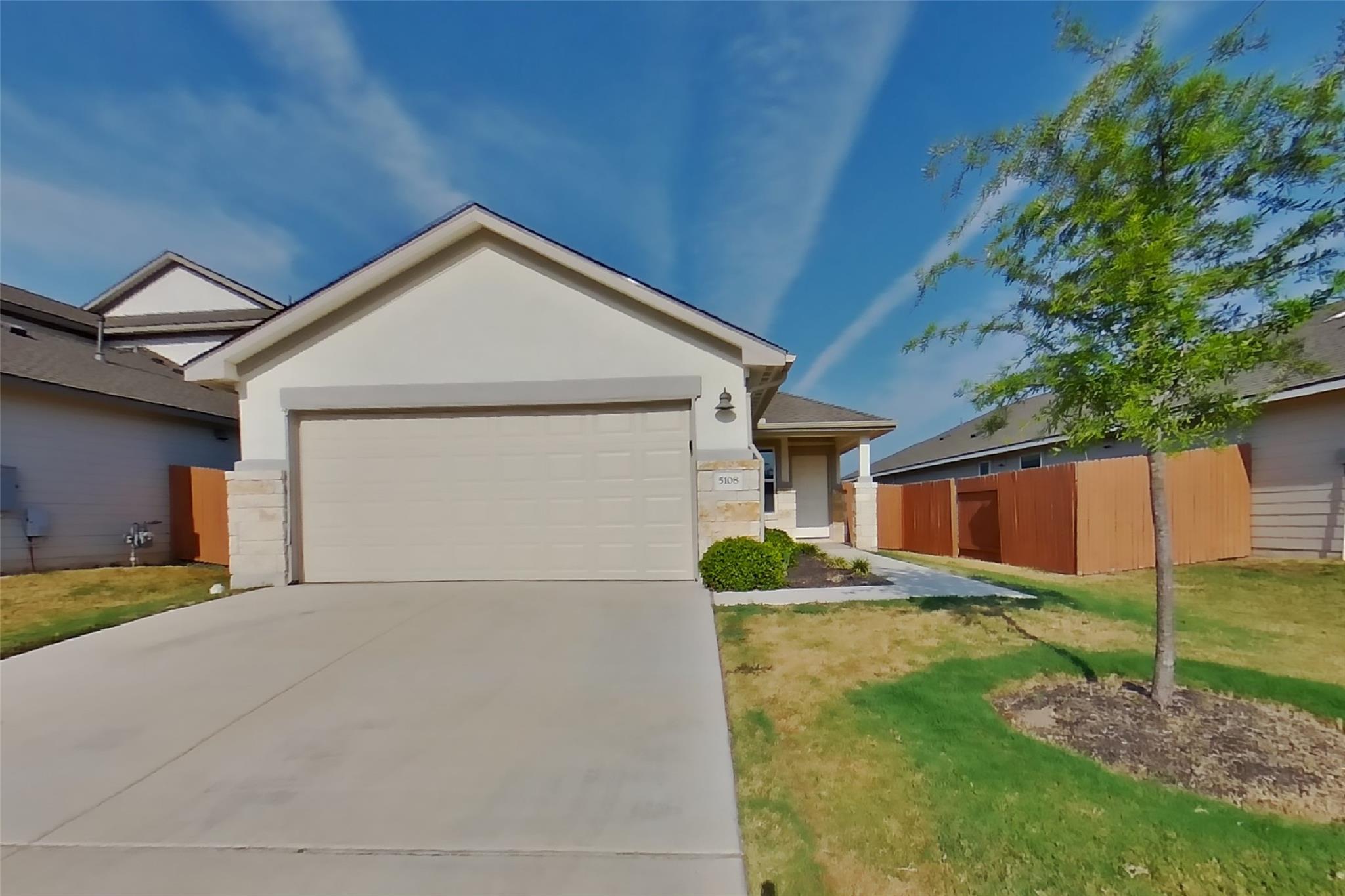 Clean lines and a spacious driveway define this m
