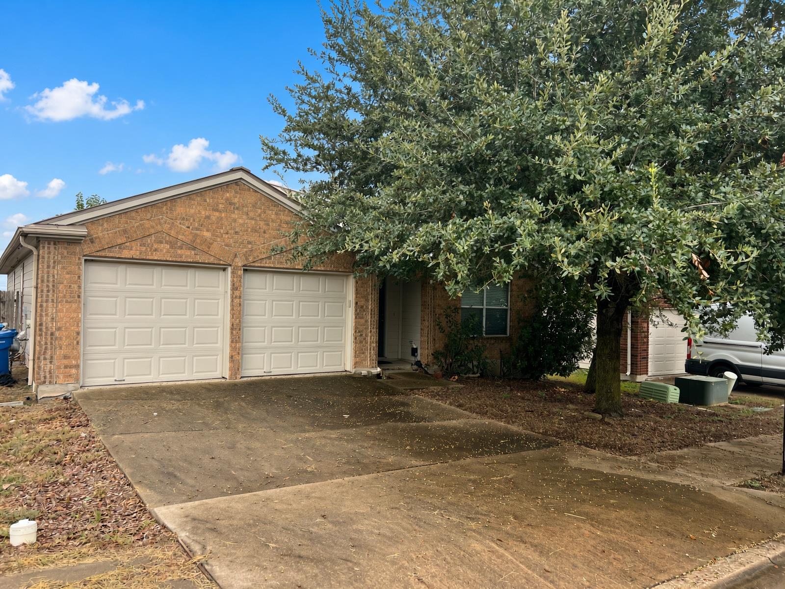 A classic brick exterior and private driveway are