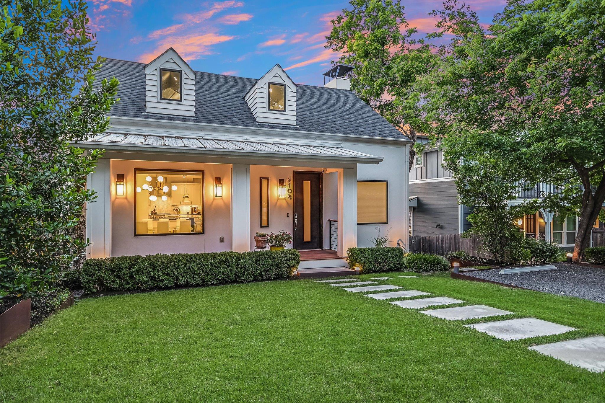 Gabled dormers and a deep covered porch highlight