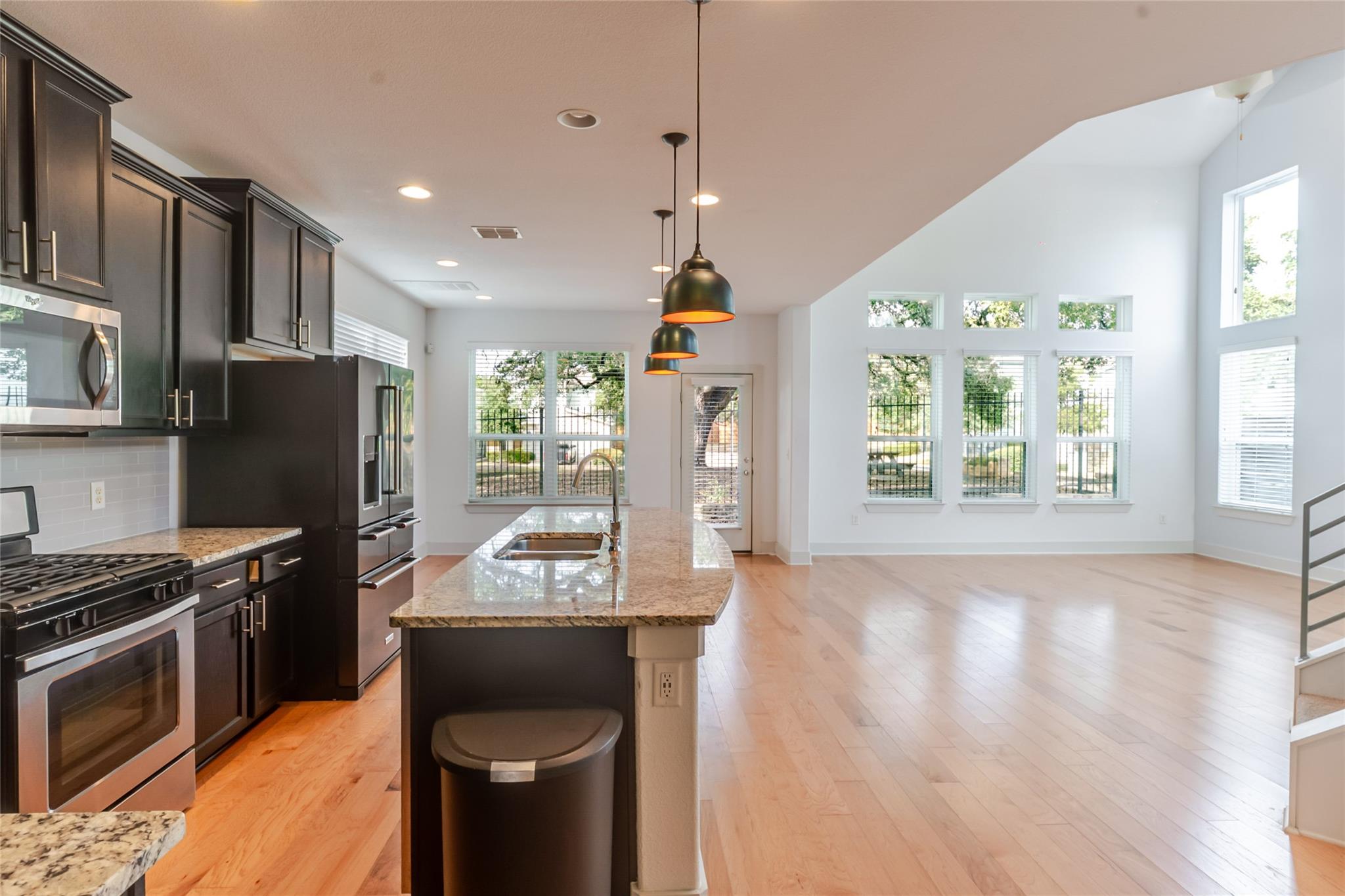 Gleaming hardwood floors and a spacious granite i