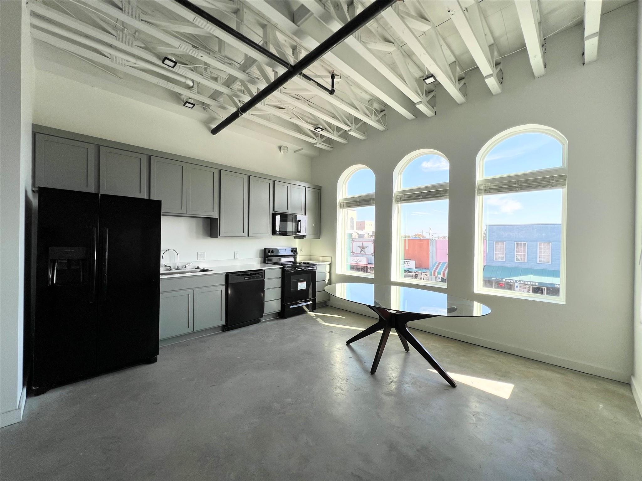Arched windows frame city views in a striking mod