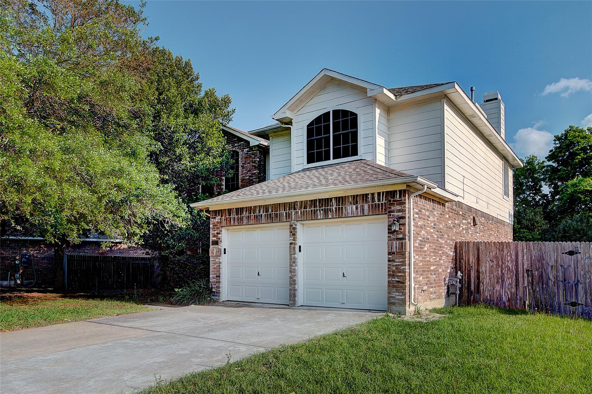 A classic brick and siding exterior features a tw