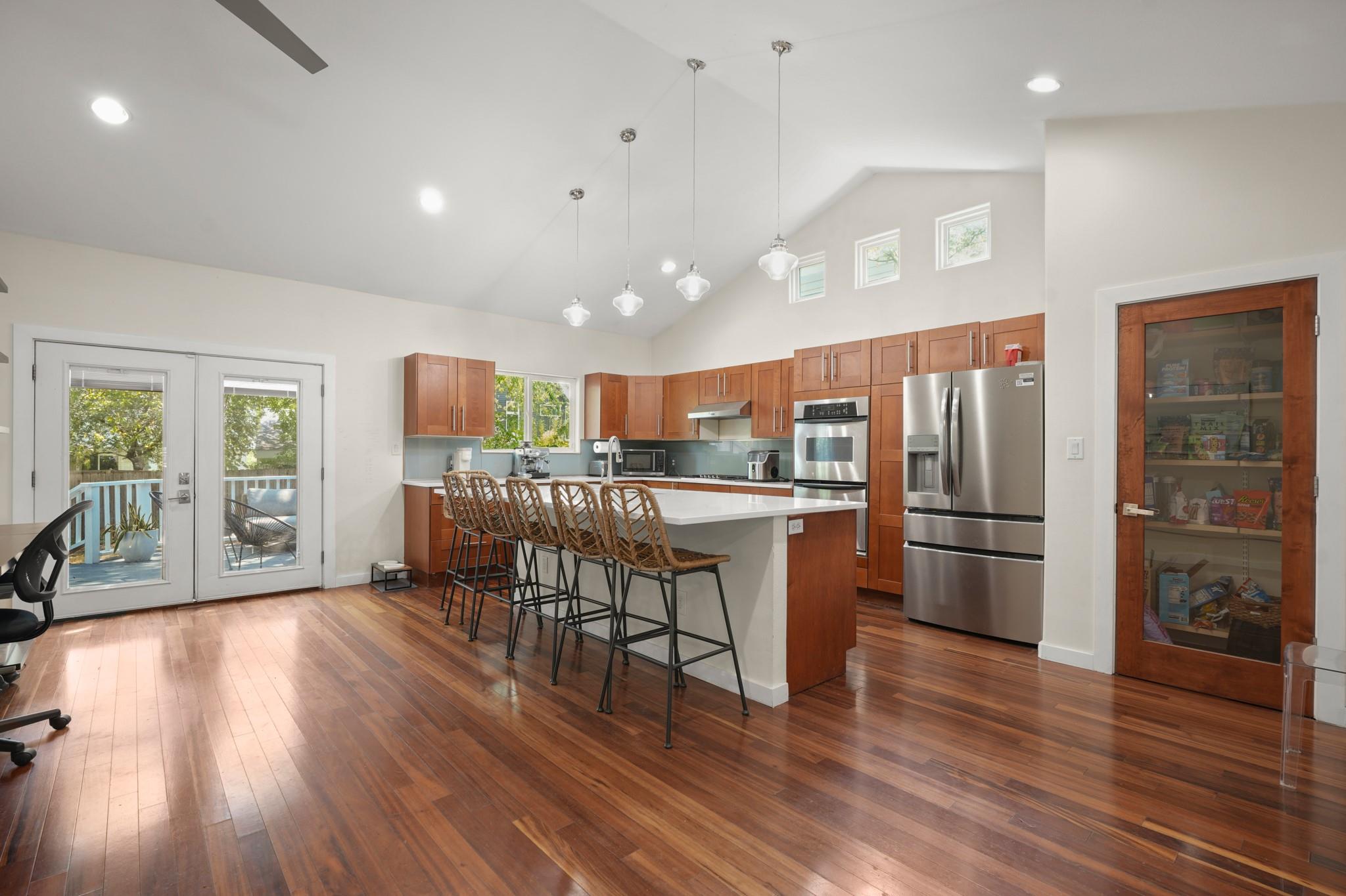 Rich hardwood flooring anchors the modern kitchen