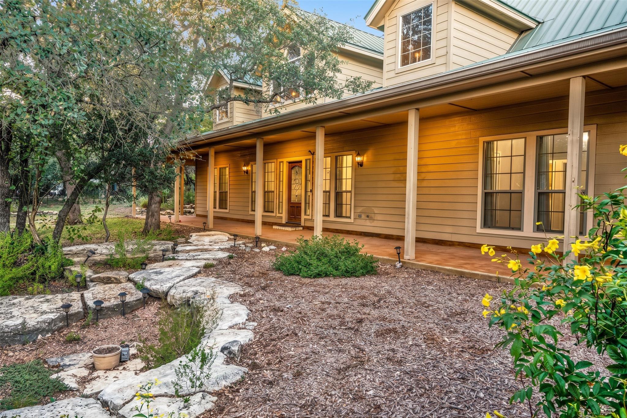 An inviting covered front porch spans the length 