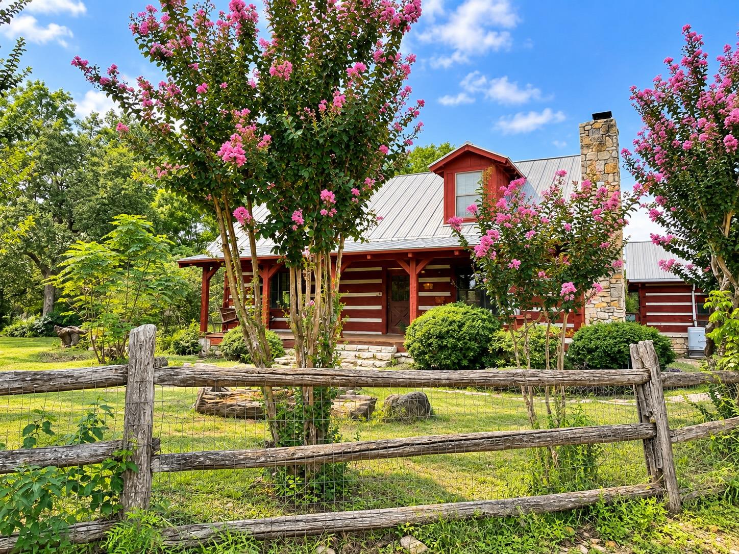 A charming log cabin with a classic metal roof an