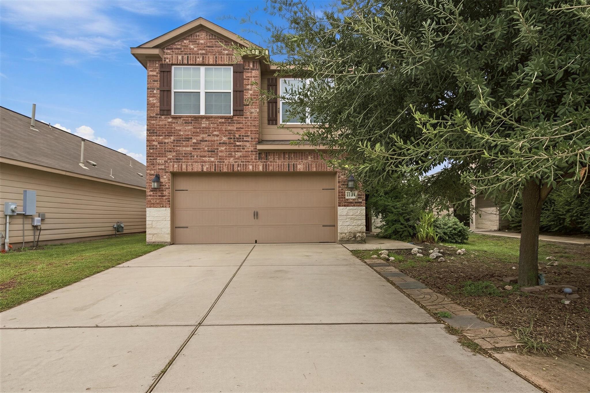 A spacious concrete driveway leads directly to a 