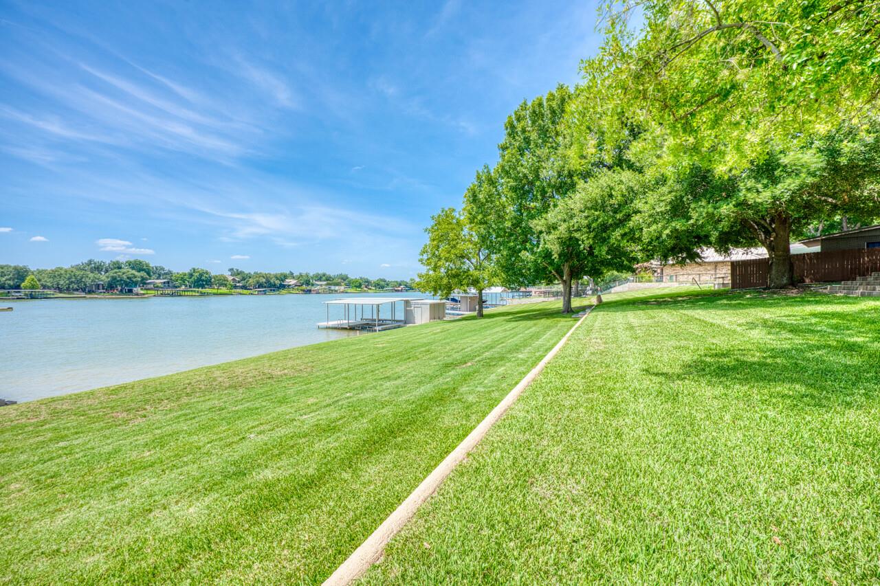 Lush grassy lawns slope gently toward the water u