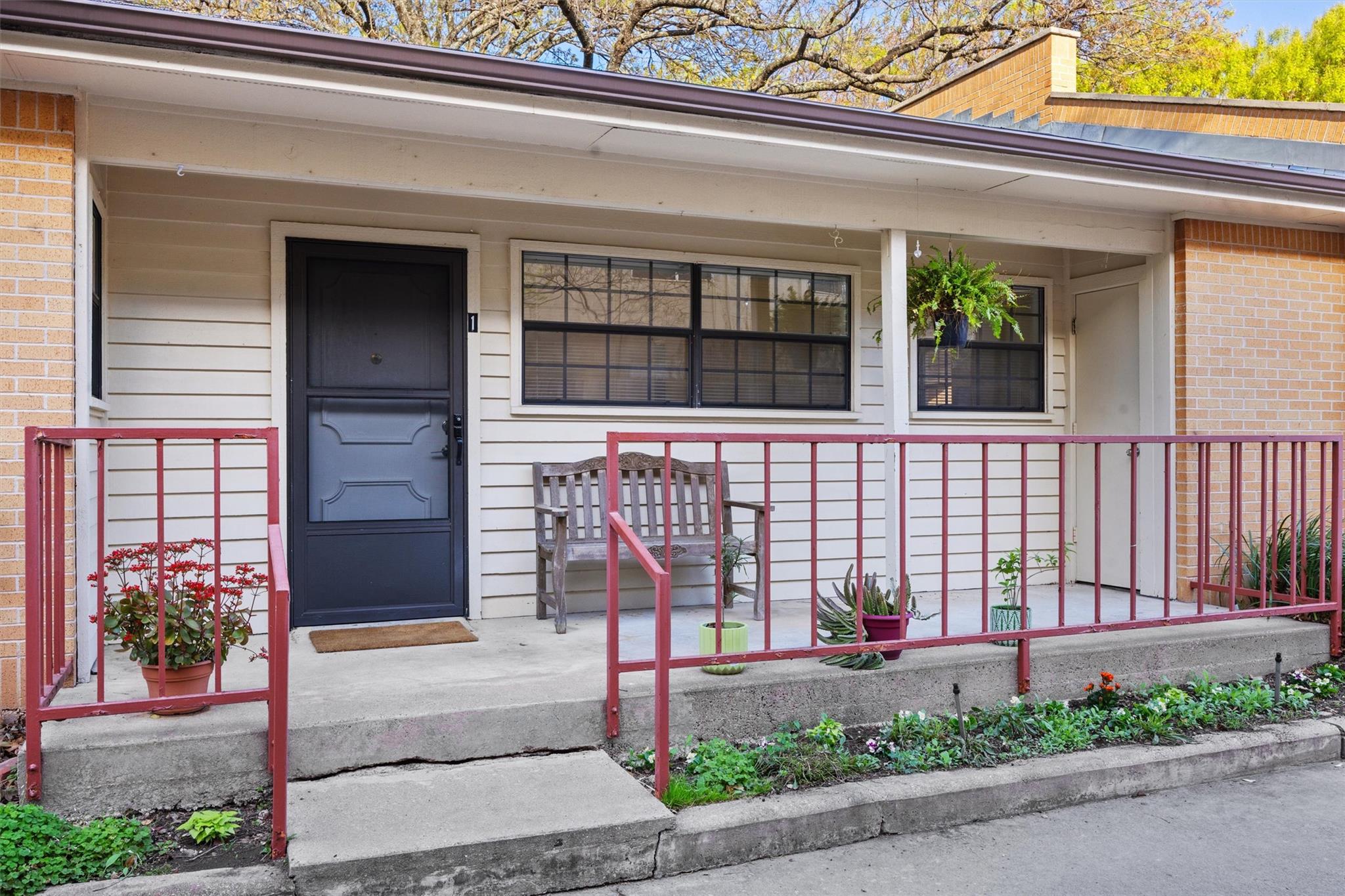 An inviting front porch with brick accents create