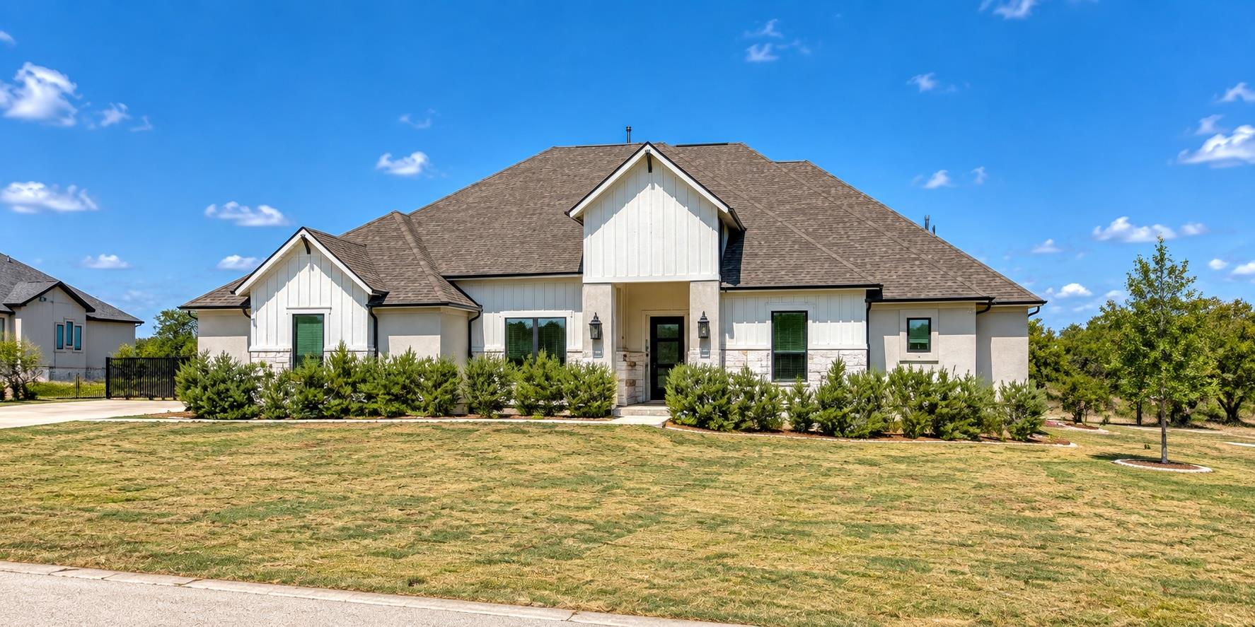 An asphalt shingle roof and Board and Batten sidi