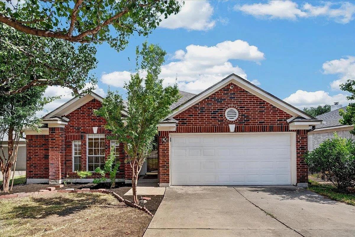 A classic brick exterior and concrete driveway we
