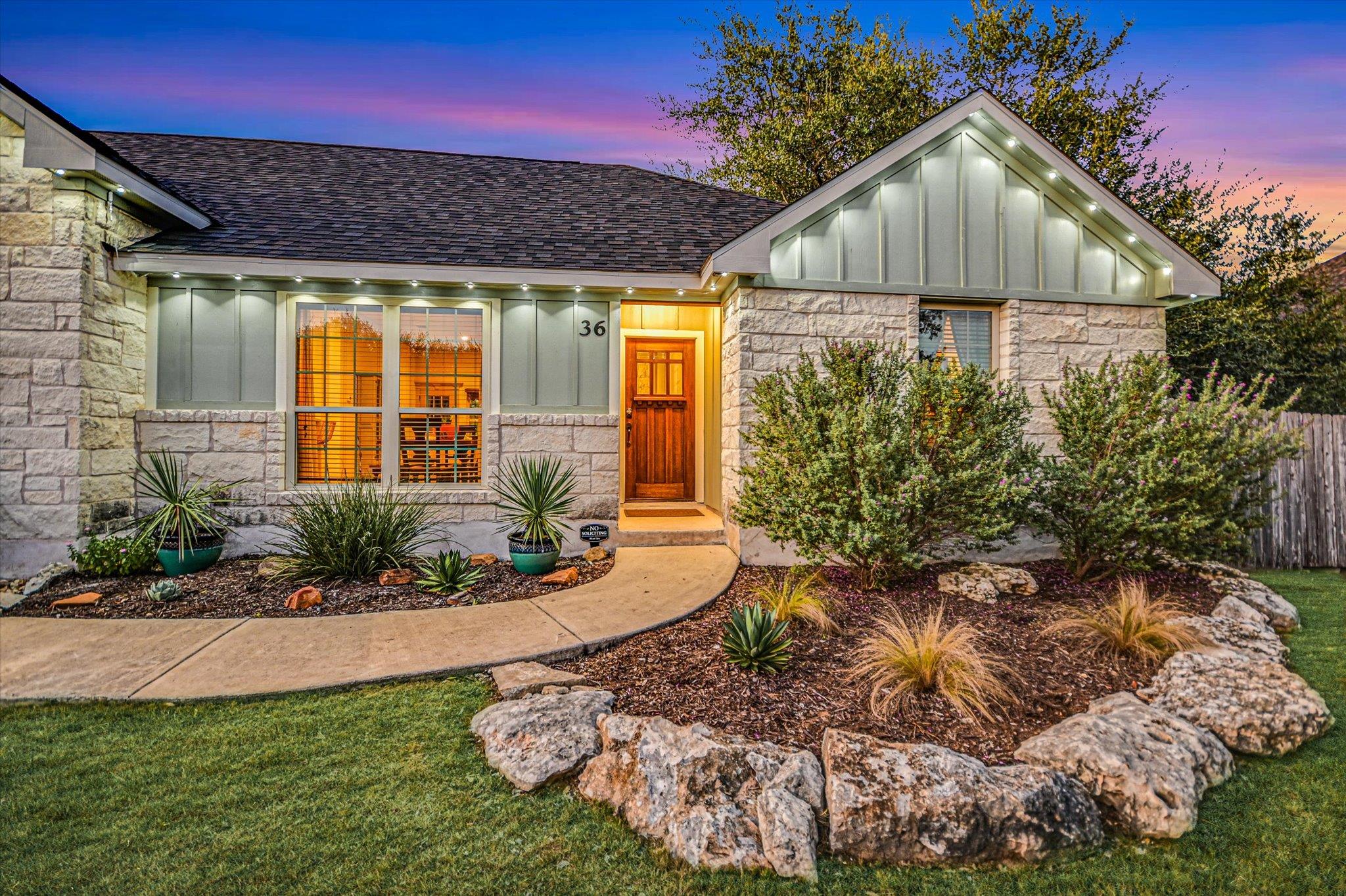 Artfully arranged stone landscaping borders a con