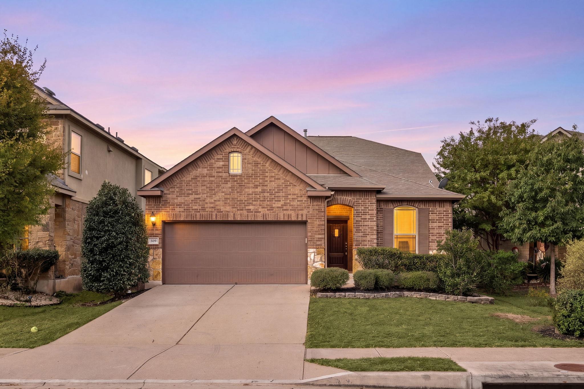 A classic brick exterior and a concrete driveway 