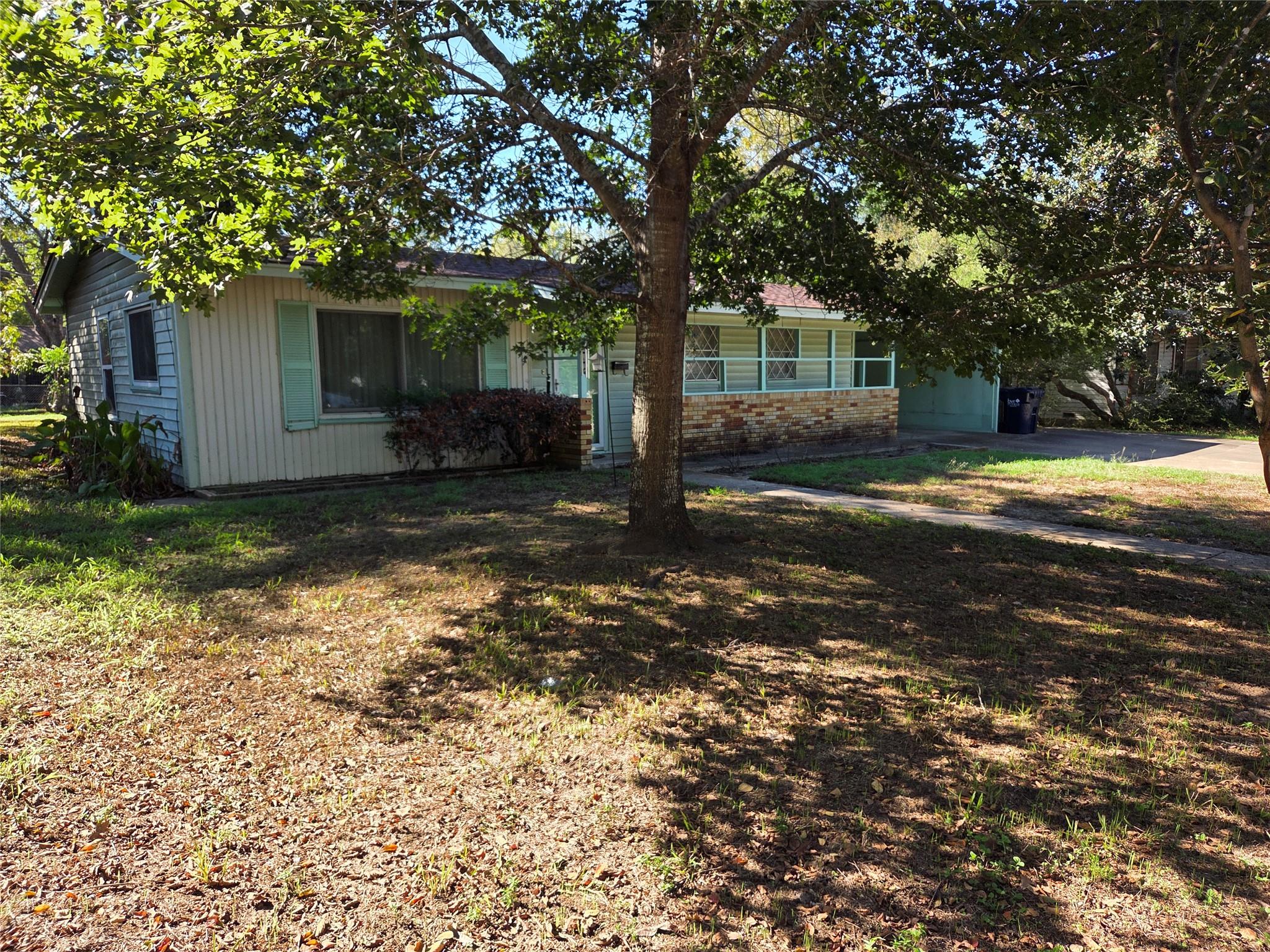Mature trees shade the front lawn of this classic