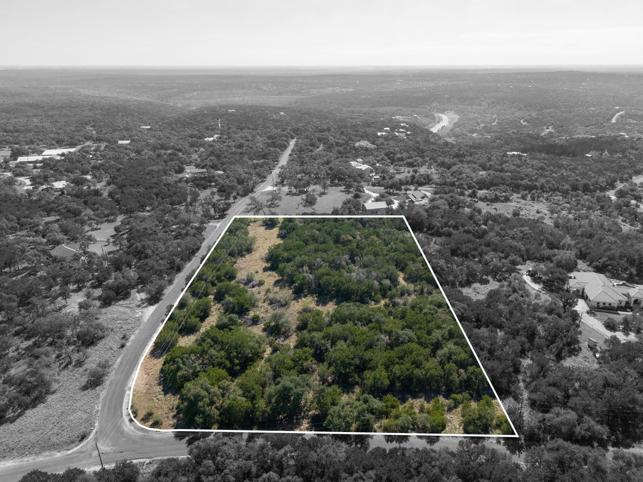 Mature trees blanket a generous acreage homesite 