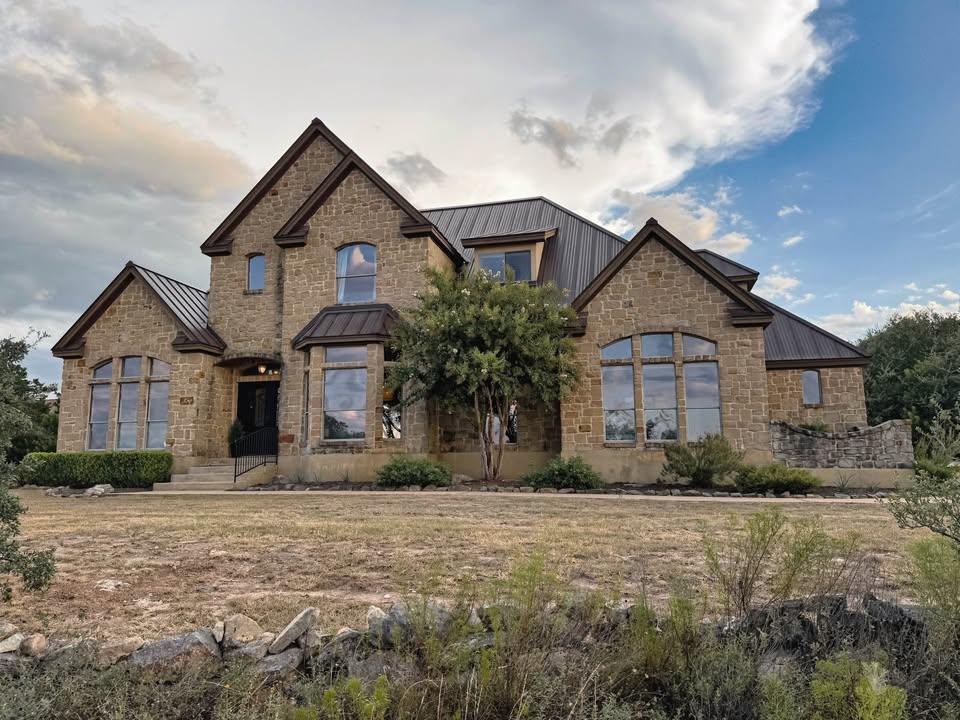 Striking stone architecture and a metal roof defi