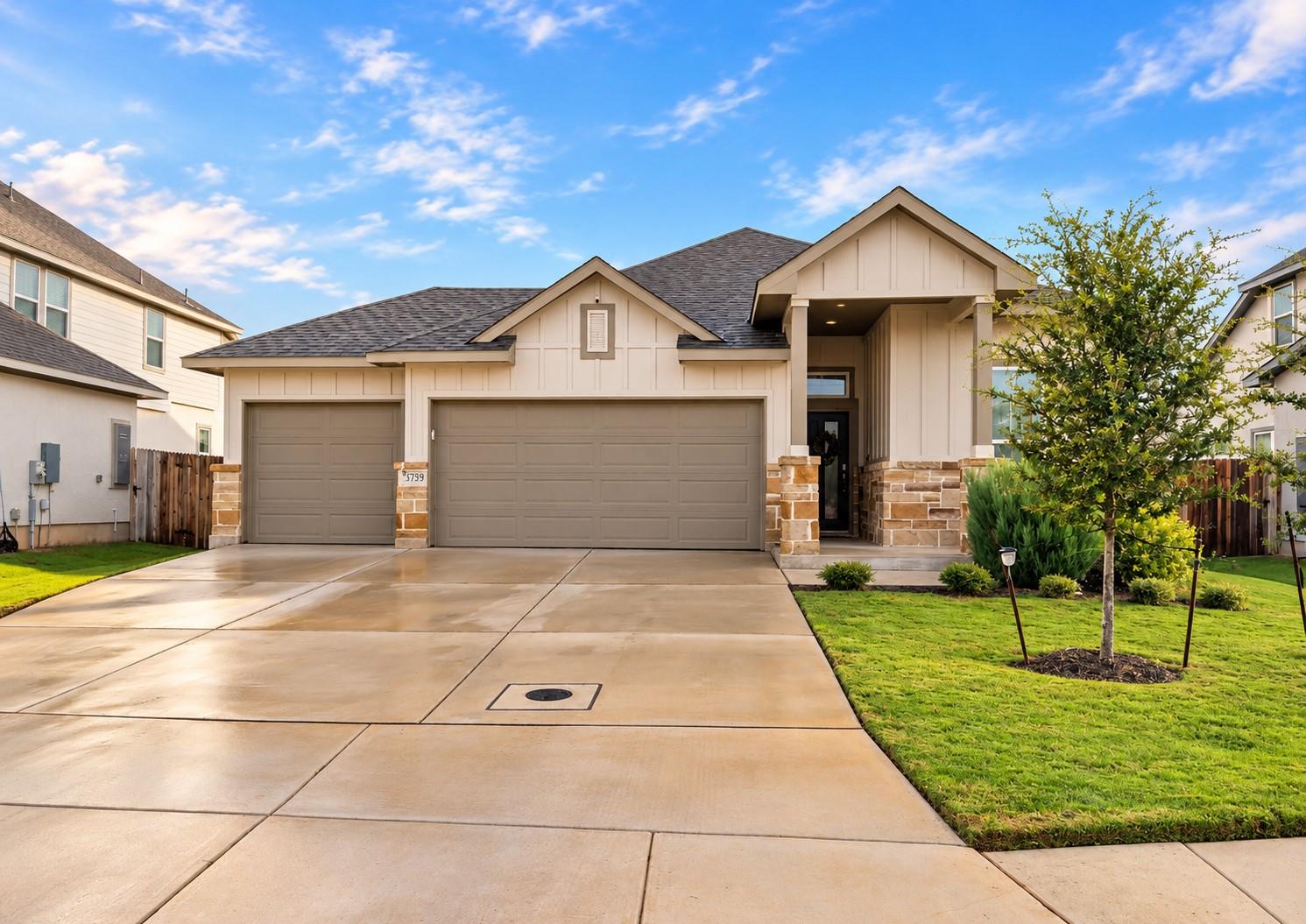 An expansive concrete driveway leads to this mode