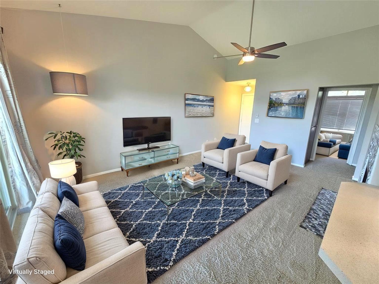Living room featuring ceiling fan, carpet, and hi