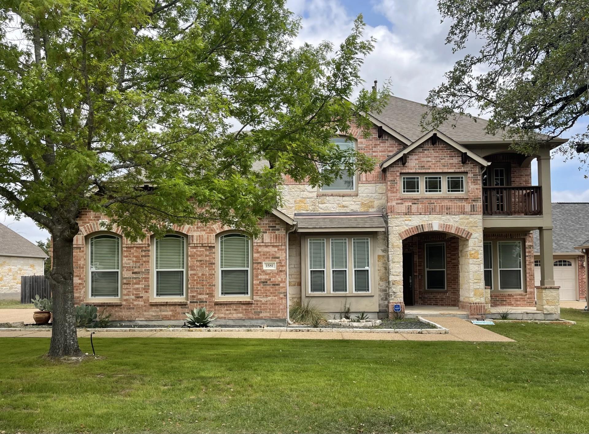 Stately brick and stone accents define the facade