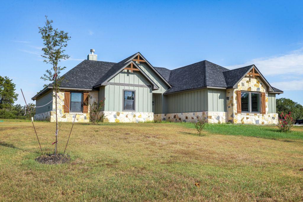 Gable rooflines and rustic stone accents highligh
