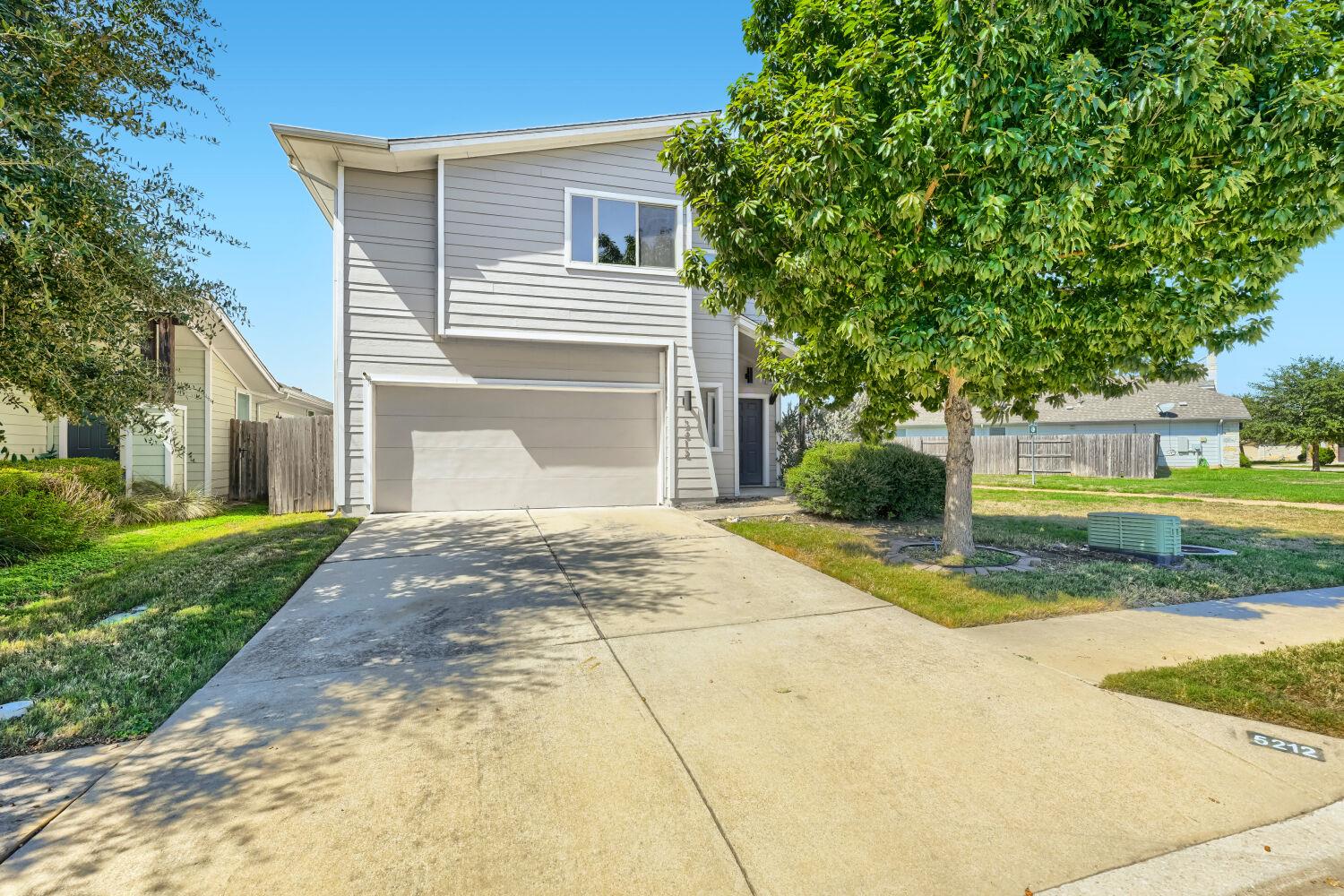 A spacious driveway leads directly to the attache