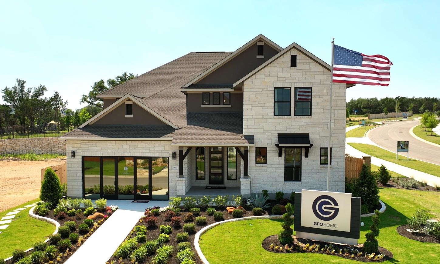 An elegant stone and stucco elevation features a 