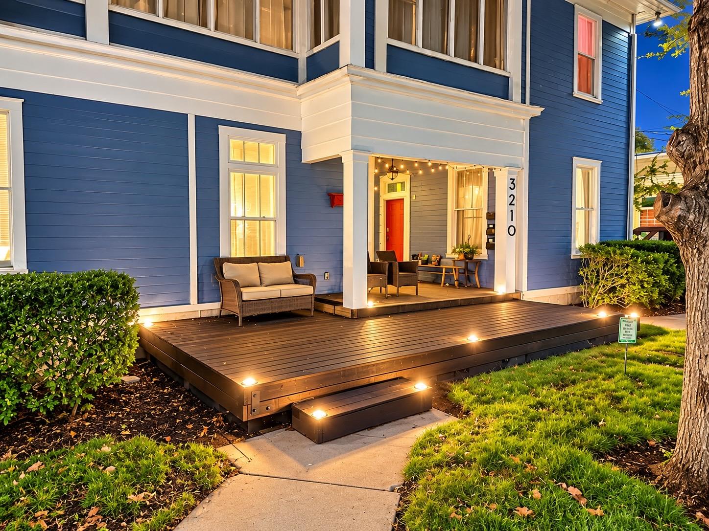 A spacious wooden front porch welcomes guests to 