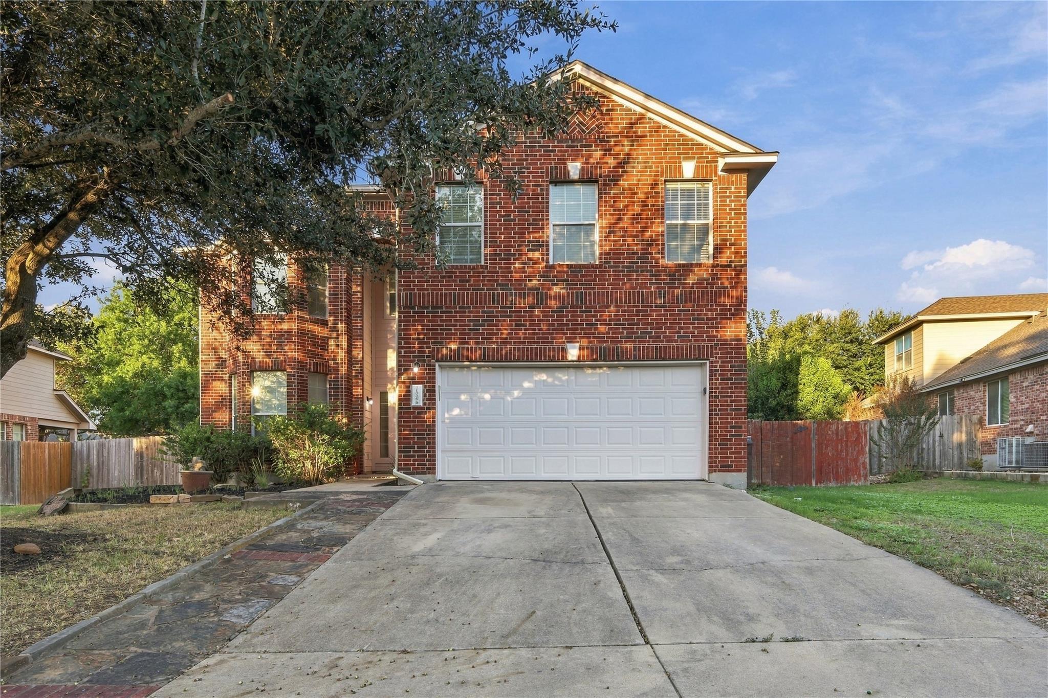 A spacious concrete driveway leads directly to a 