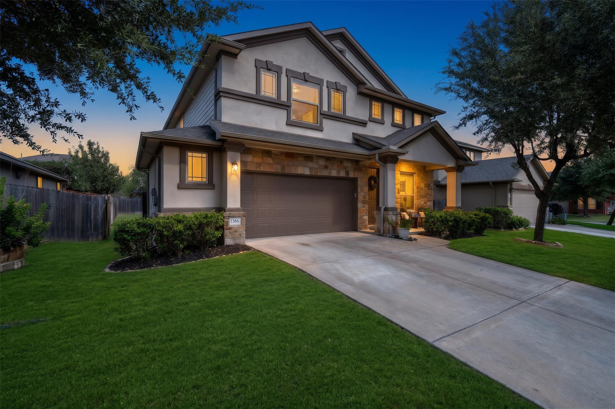 A spacious driveway leads to this modern two-stor