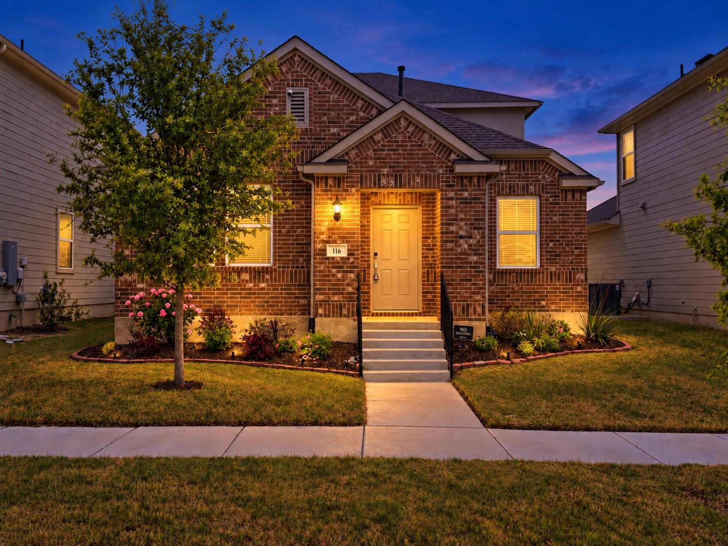 Inviting classic brick elevation features a cover