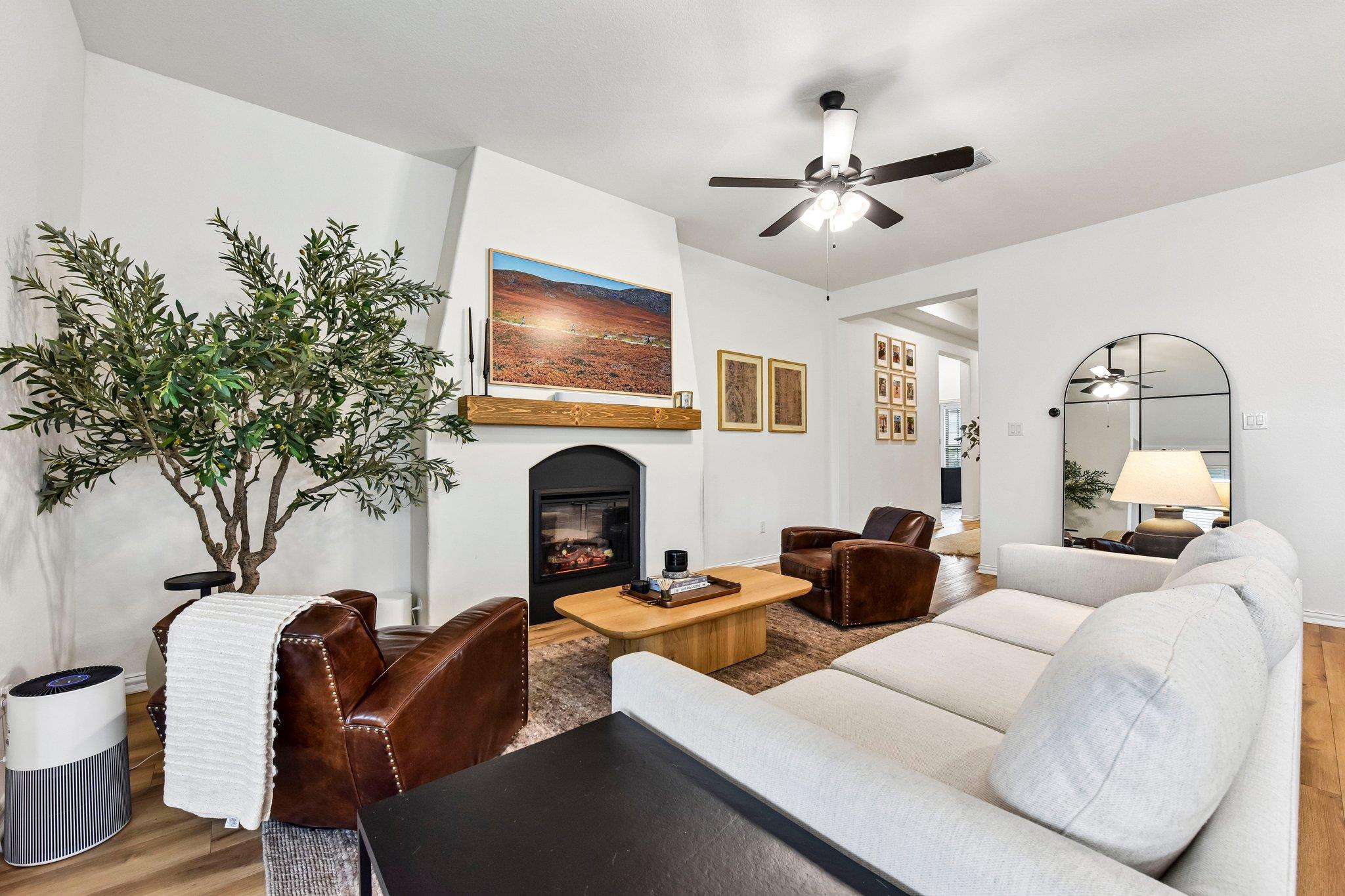 An inviting hearth centers this comfortable livin