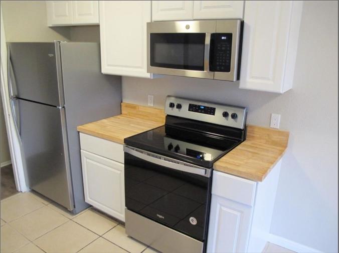 Gleaming butcher block countertops highlight this